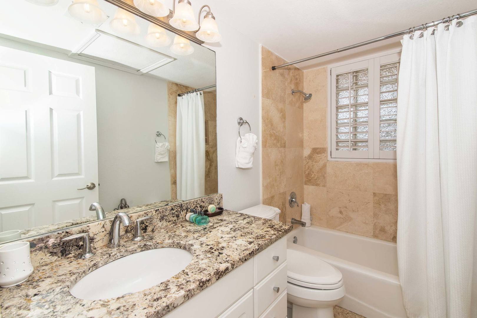 Both lower level bedrooms share this hall bathroom equipped with shower bath.