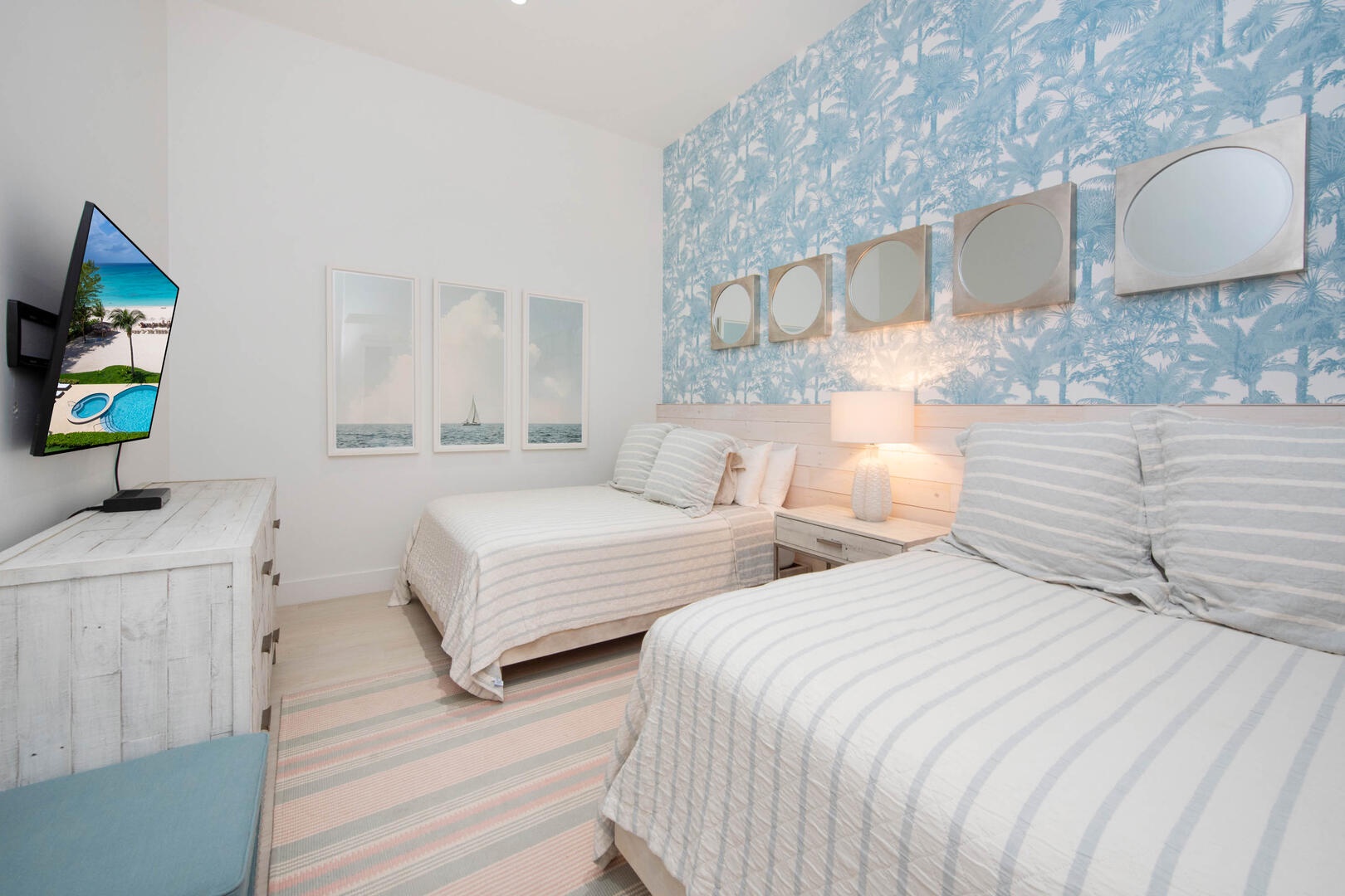 Bedroom 2 with two queen beds and a cable HD TV.