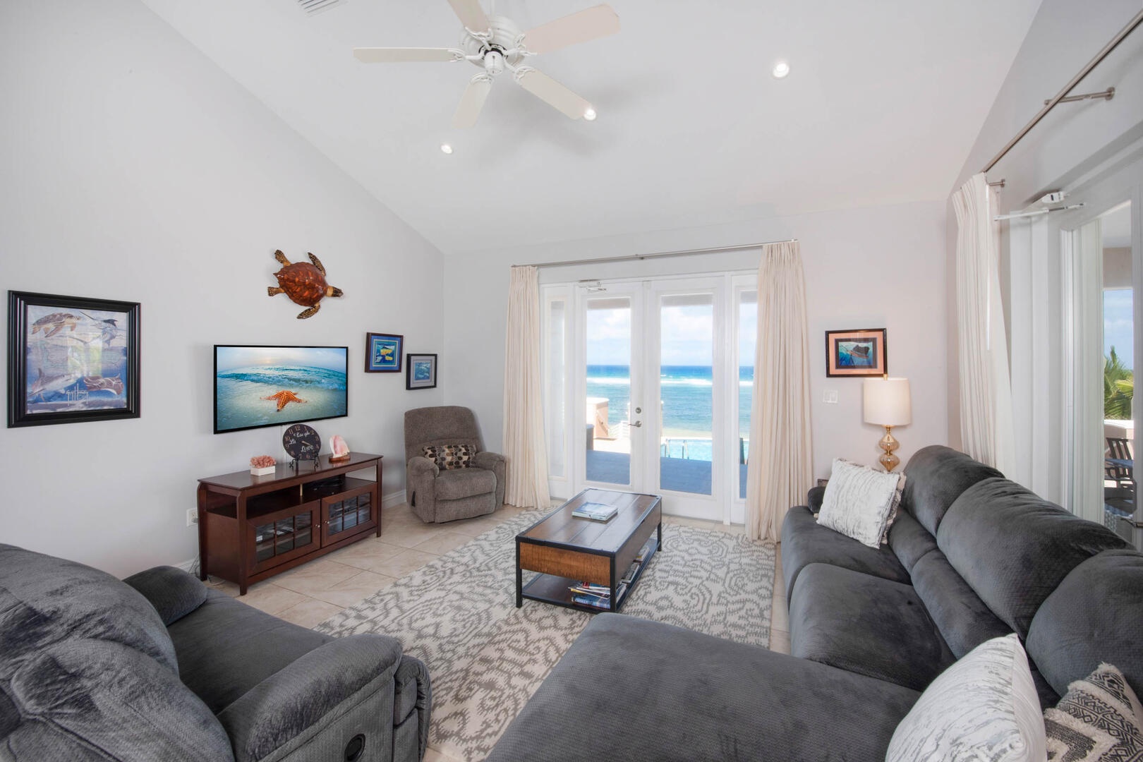 An enormous sectional sofa and large flat screen TV in the oceanfront living room allow everyone to hang together at the end of the day, whether they want to watch a movie or just relax.