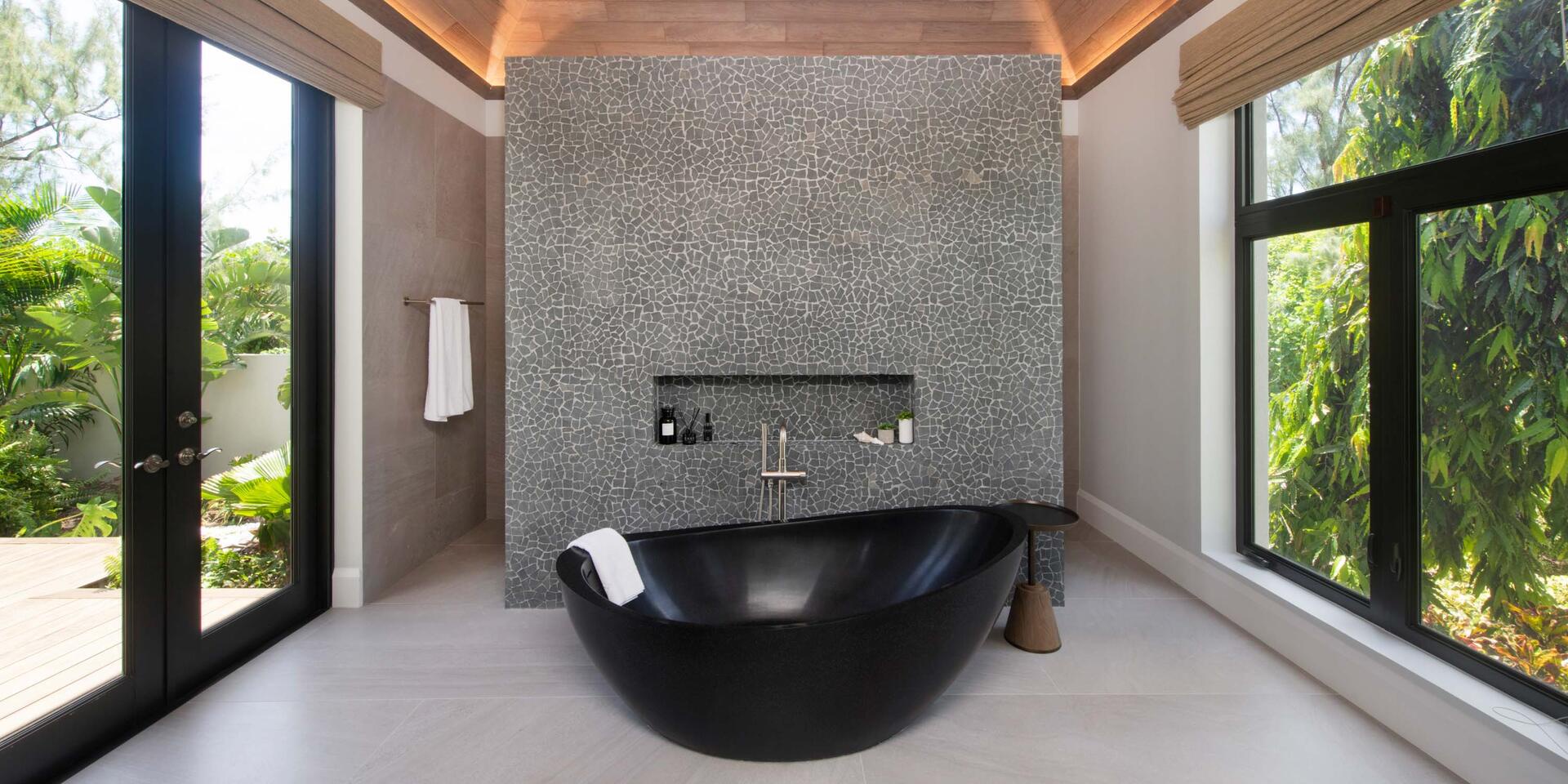 Bedroom 1 ensuite with soaking bathtub and shower on the backside of the wall. All bath and beach towels are provided.