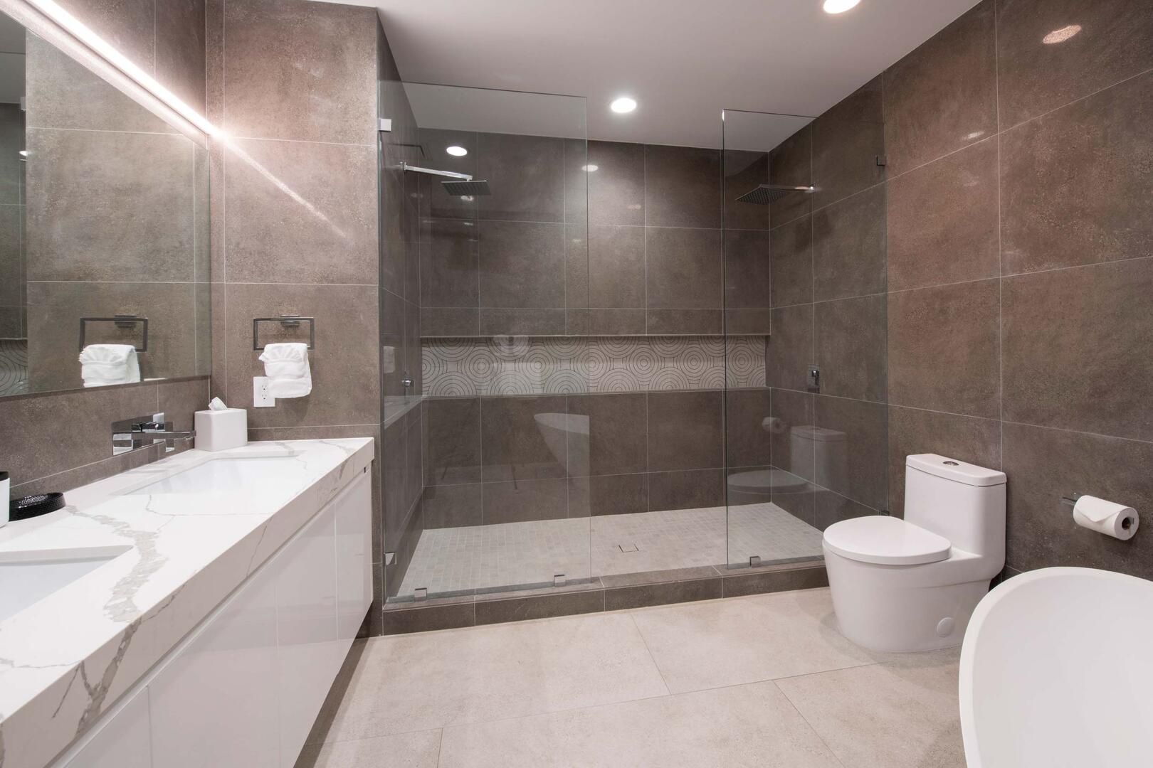 The shower is equipped with dual rainfall shower heads.
