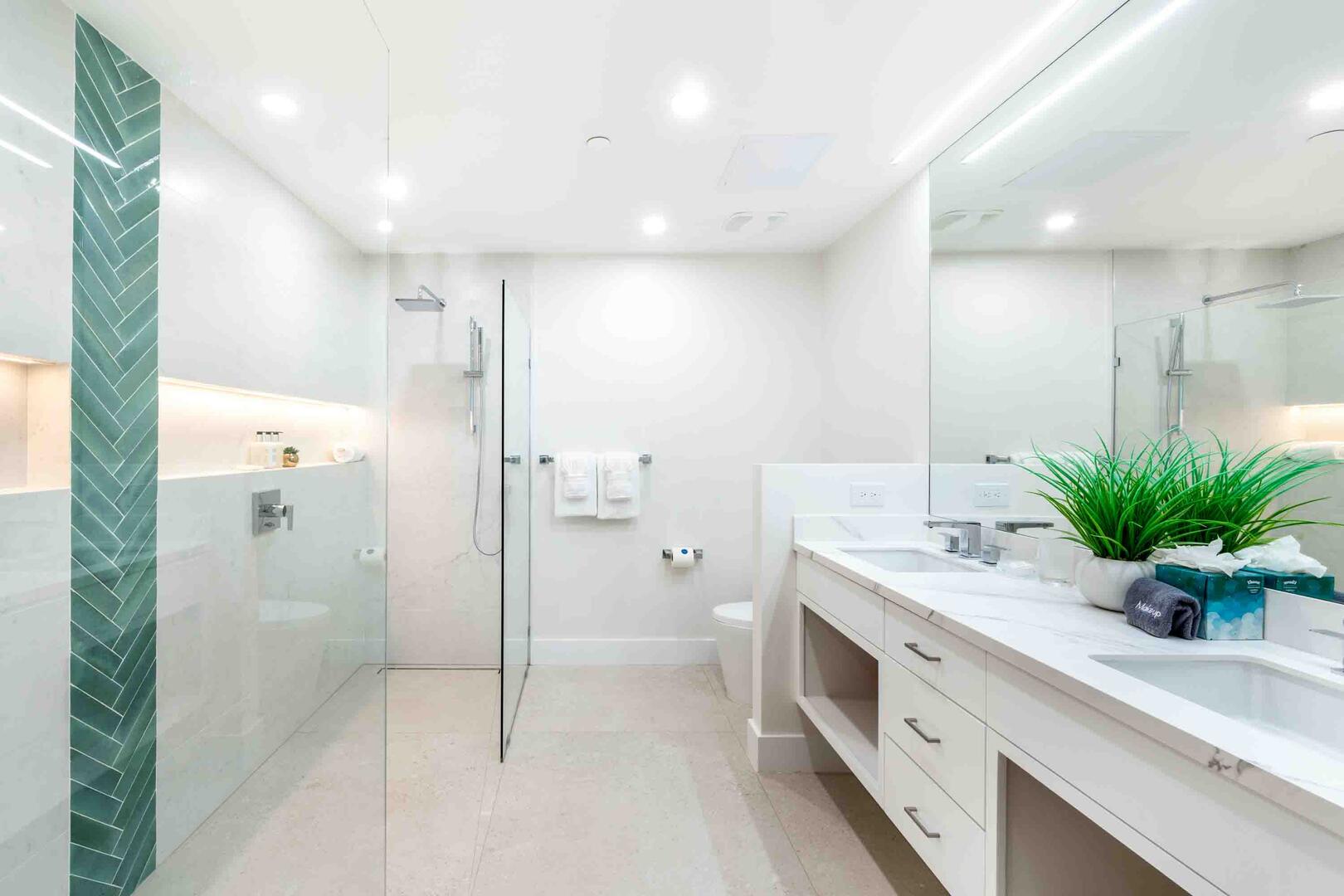 Fully renovated primary ensuite with dual vanities and double walk-in shower.
