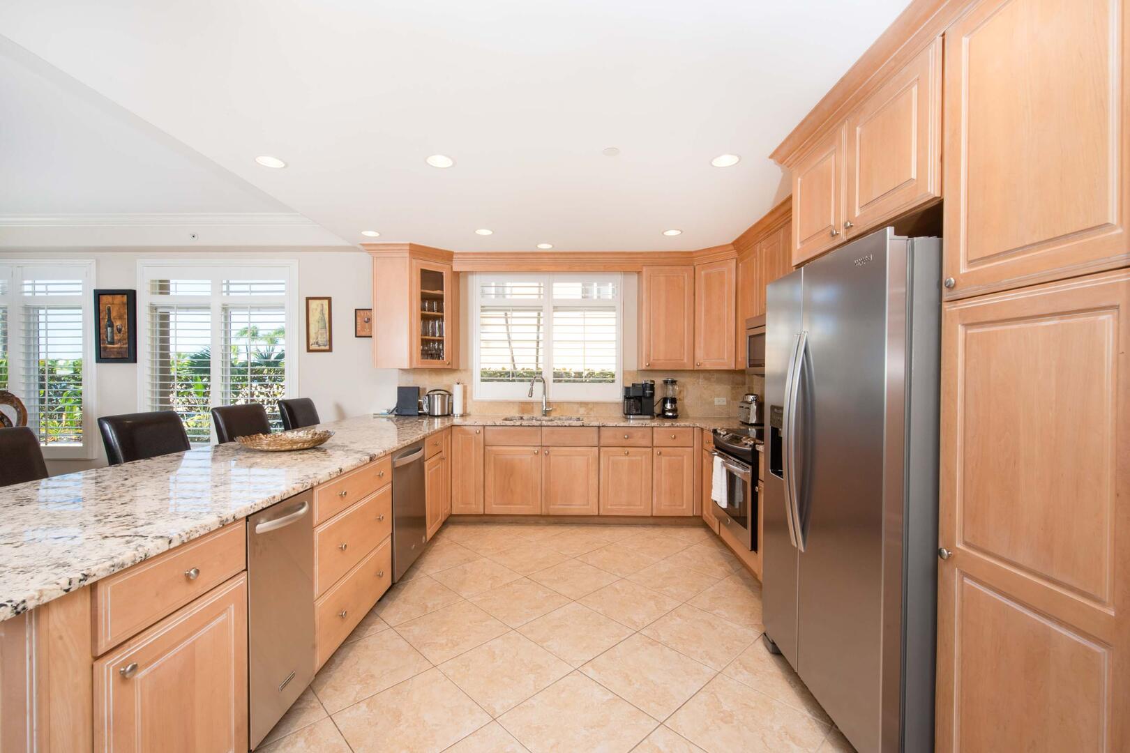 Full kitchen with modern appliances. The kitchen comes stocked with dishware, cookware, glassware, and cutlery.