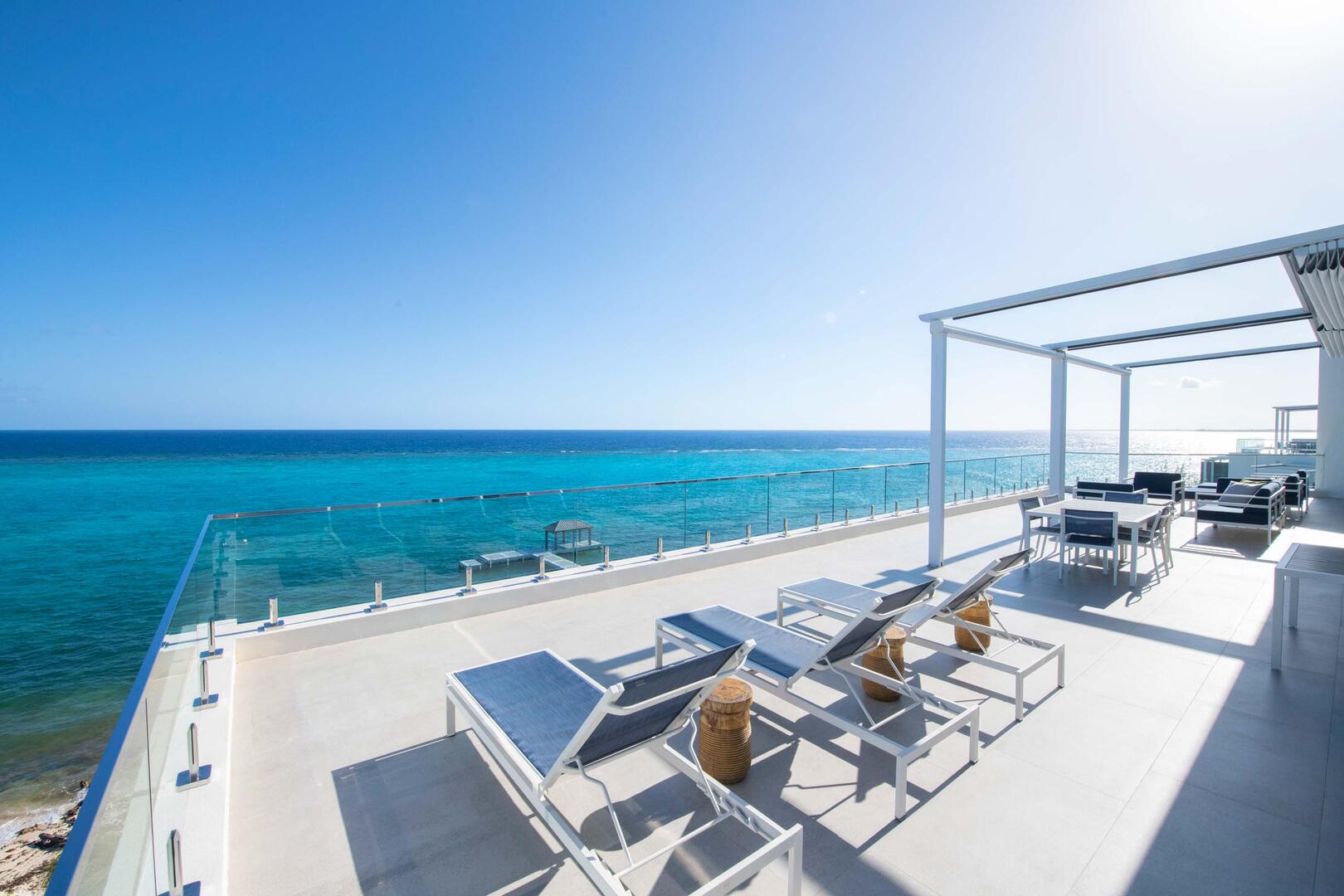 Sun beds on the ocean balcony steps off of Primary Suite #1.