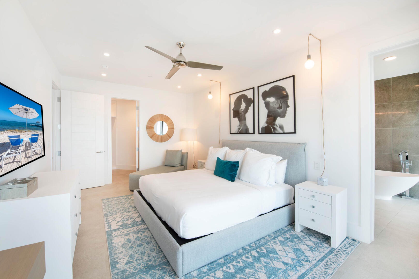 Primary Suite with ean views, walk-out access to a private open-air balcony, SmartTV, walk-in closet, desk chair.