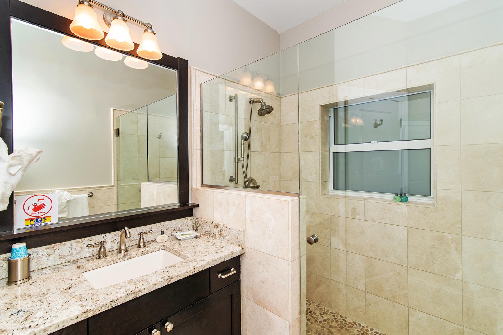 Lower South Suite bathroom with glass shower.