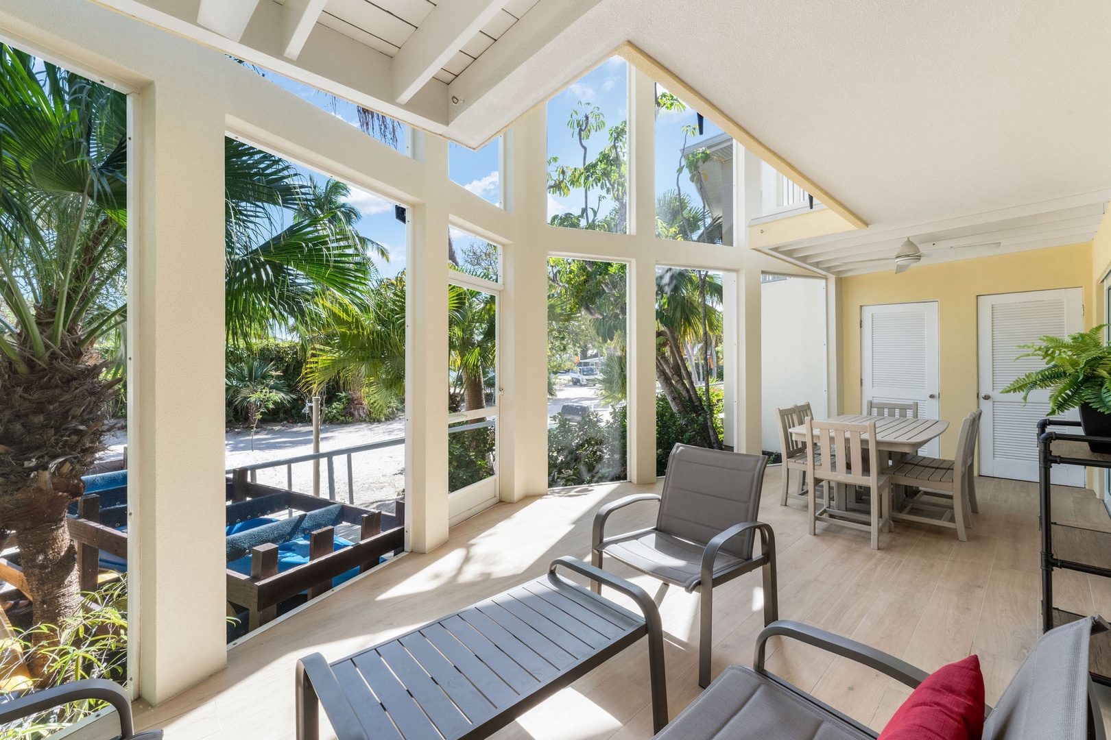Screened atrium with patio furniture. The pool is just a short walk away.