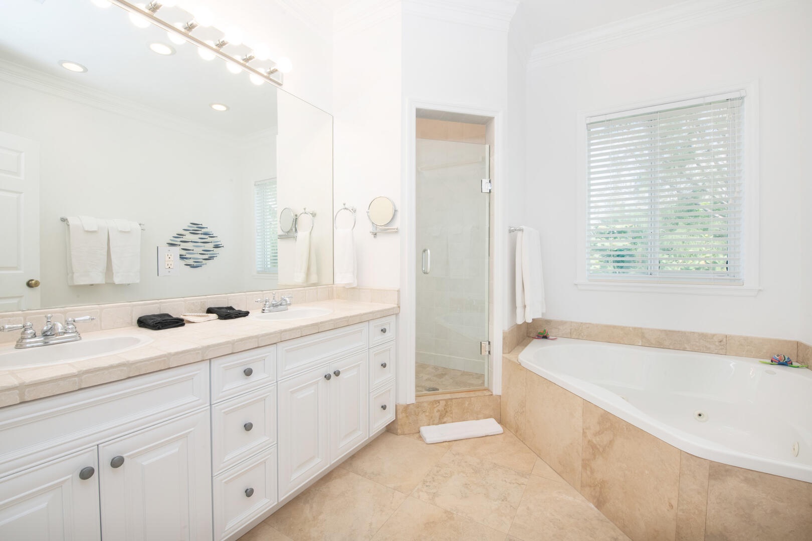 Bedroom 2 ensuite with dual vanity, soaking tub, and separate shower.