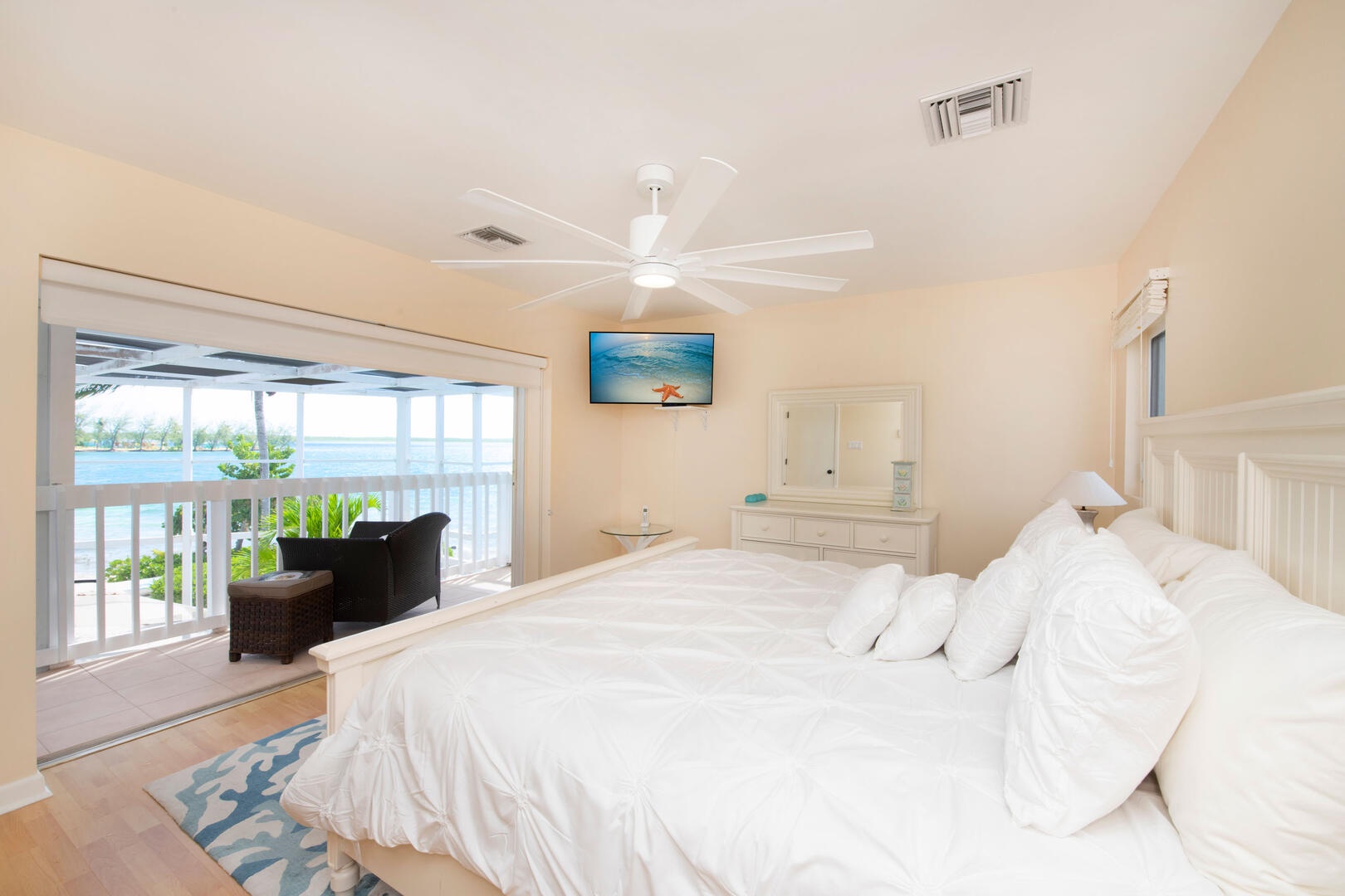 Primary Suite with king bed, television, and a private walkout balcony.