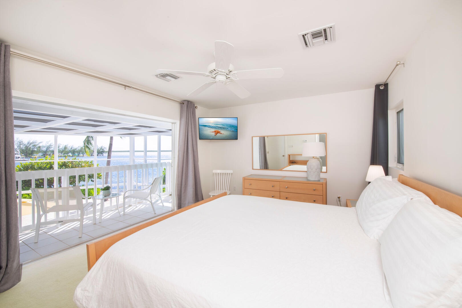 Primary Suite with king bed and television.