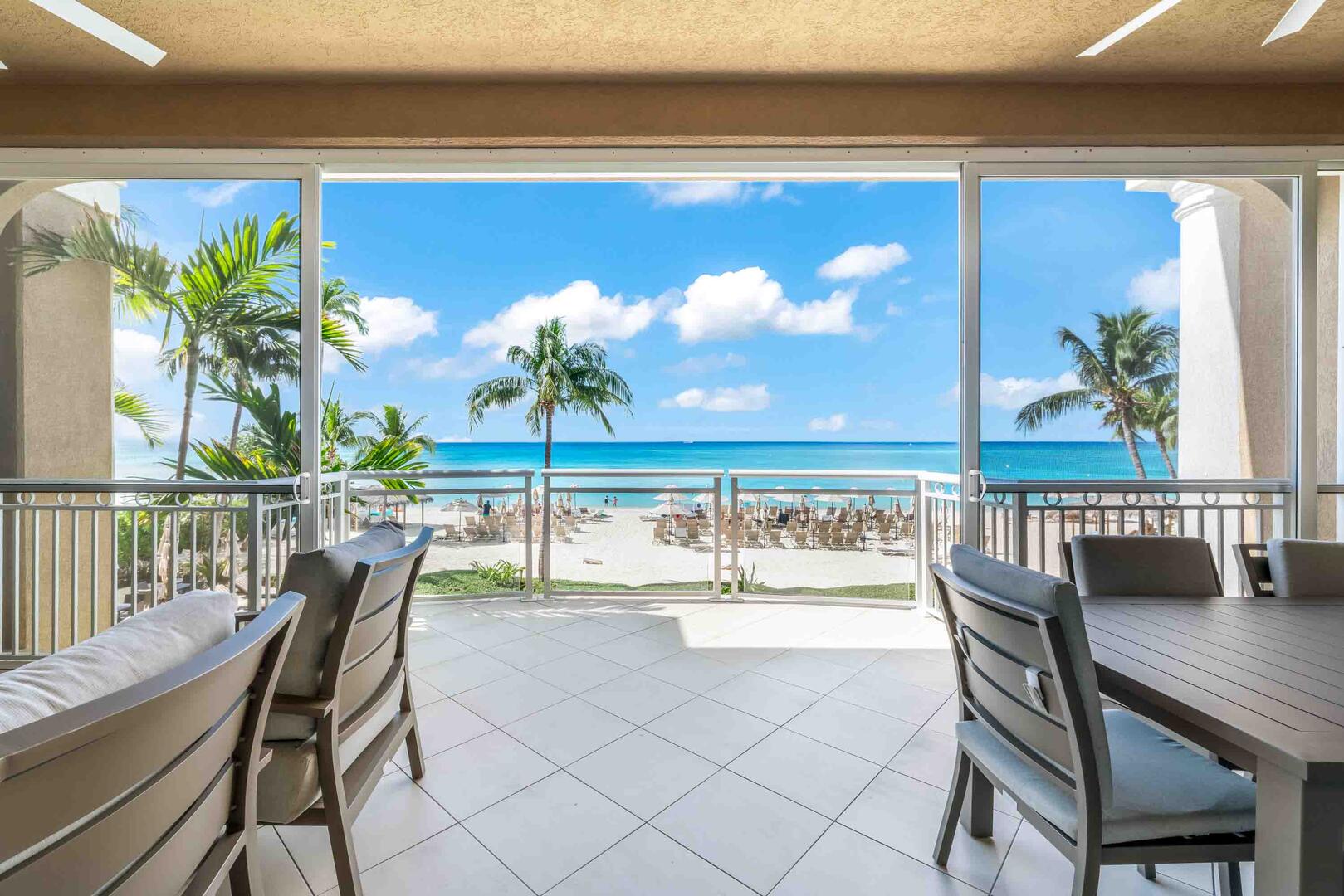 Private furnished balcony overlooking a beachfront paradise.