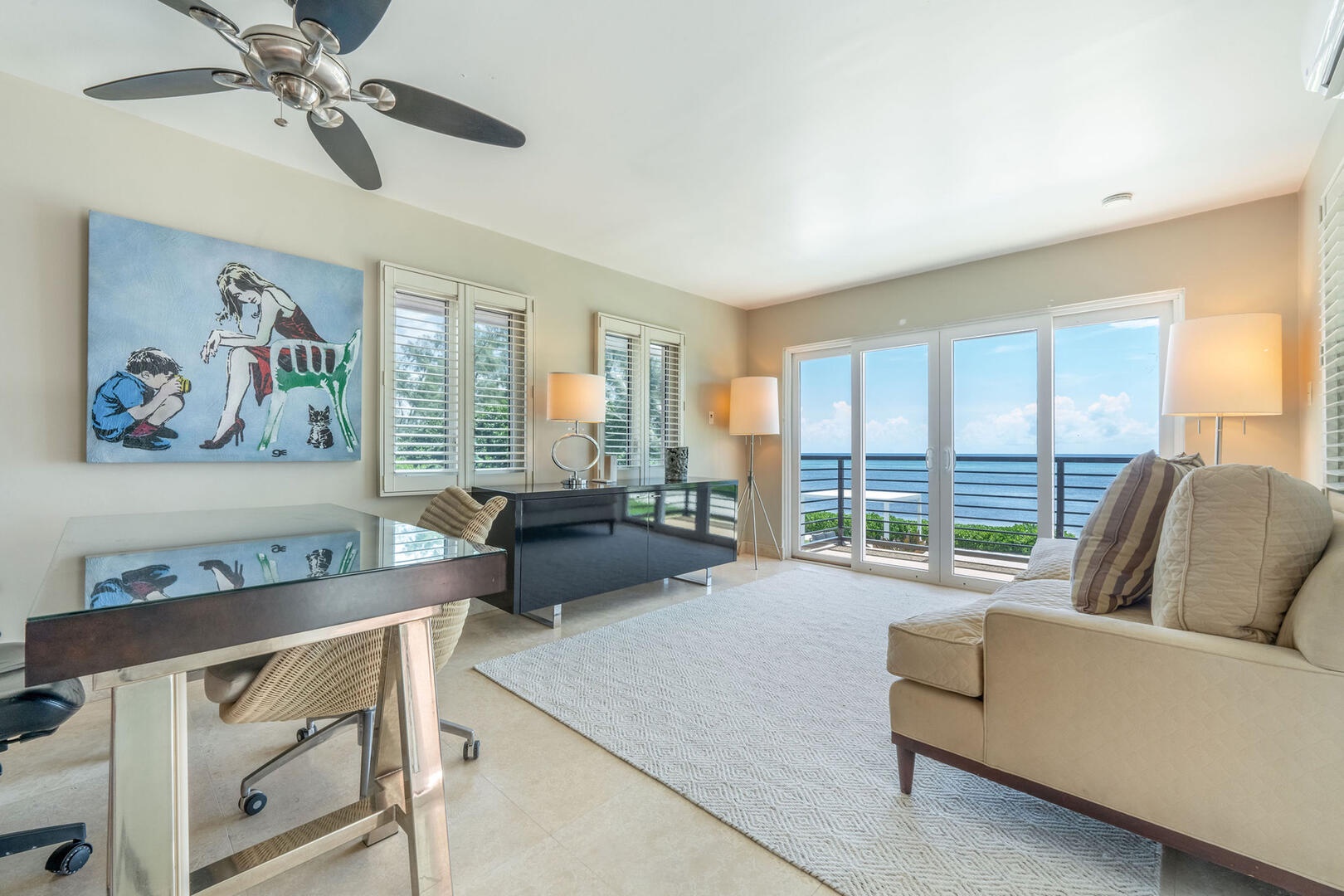 Home office on the upper level with desk, chair, sofa and a private balcony. Perfect for work-from-home-professionals.