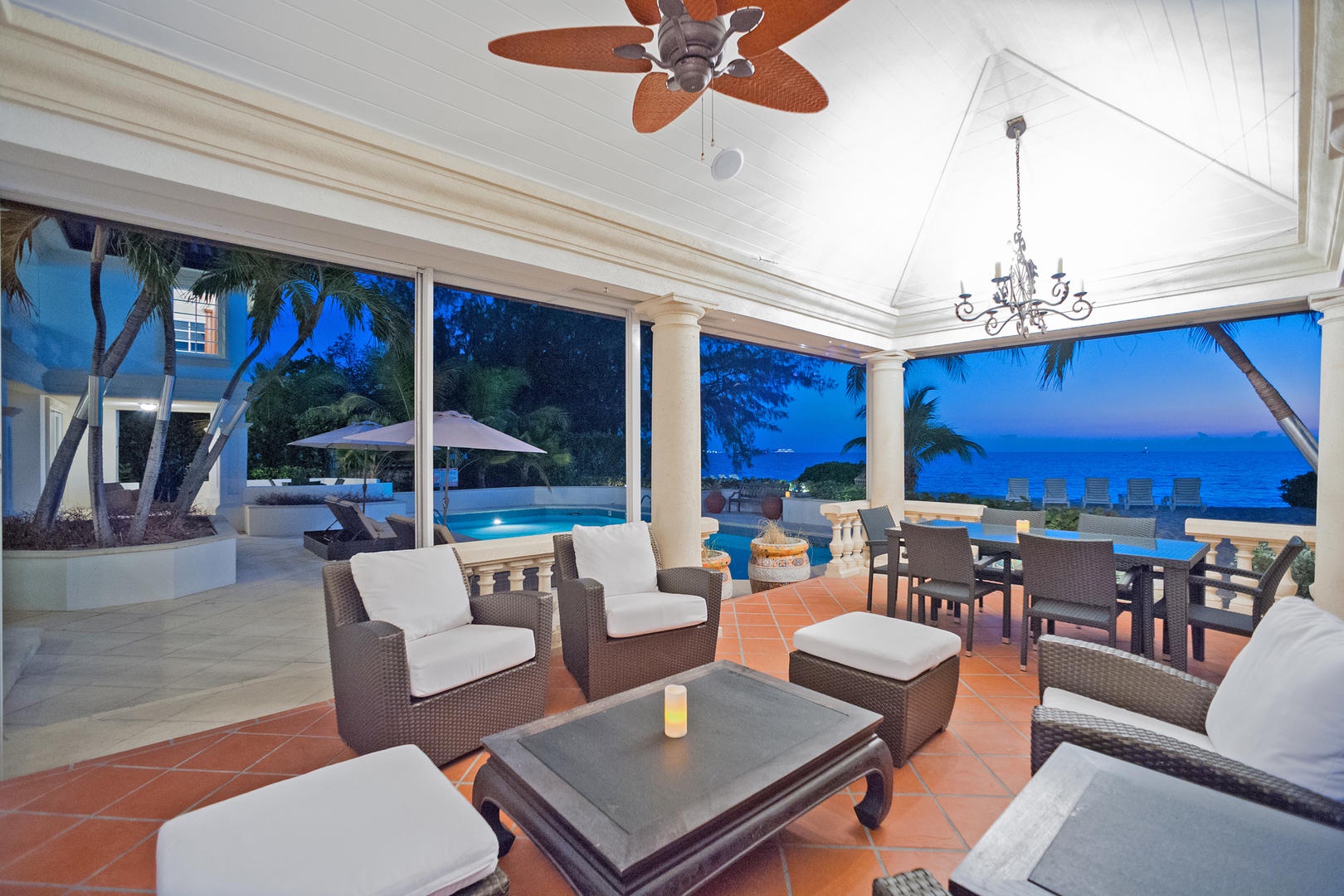 Lounge on the screened veranda for a sunset cocktail in a comfy chair.