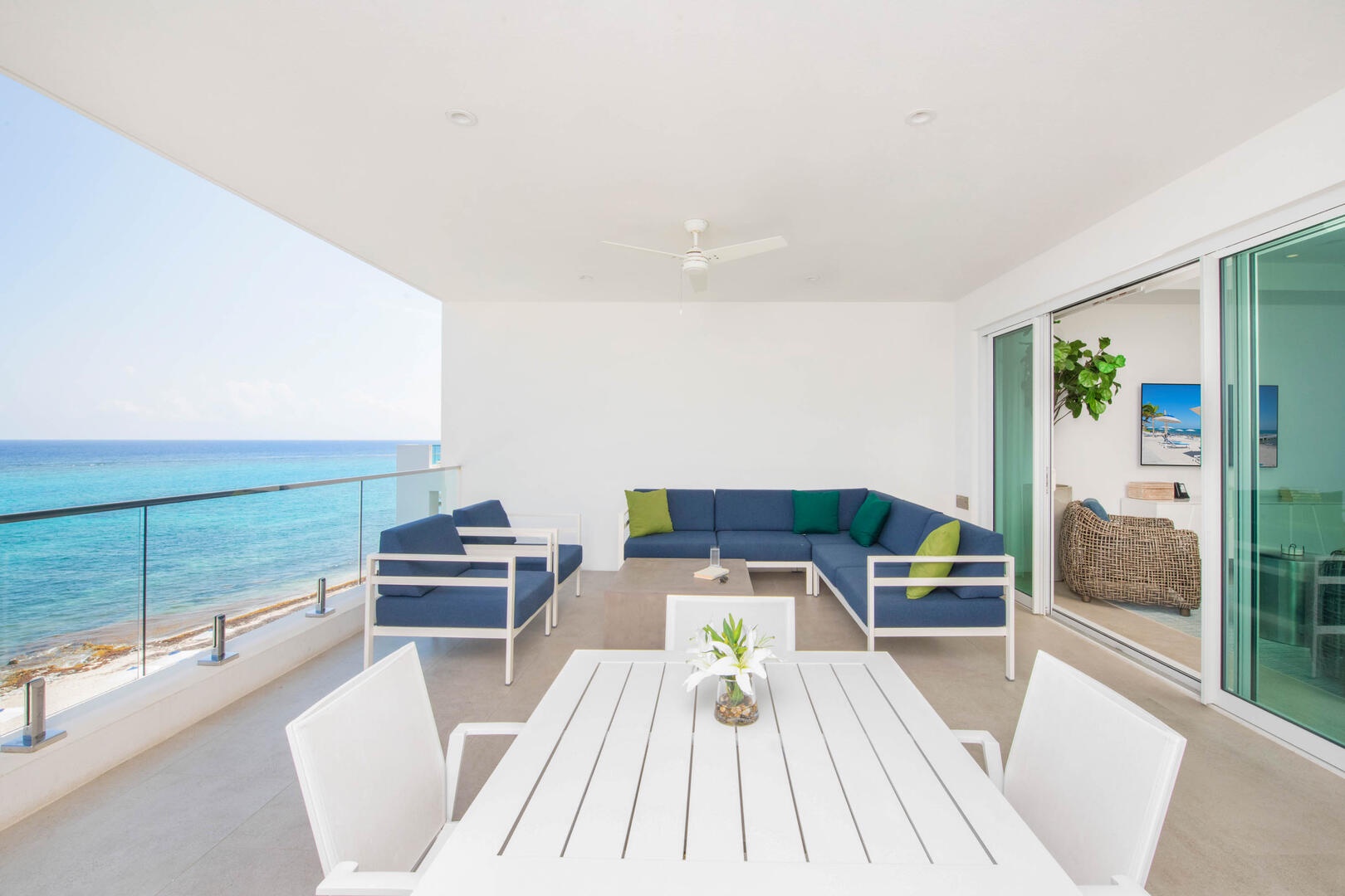 Furnished balcony with ocean views and table for four.