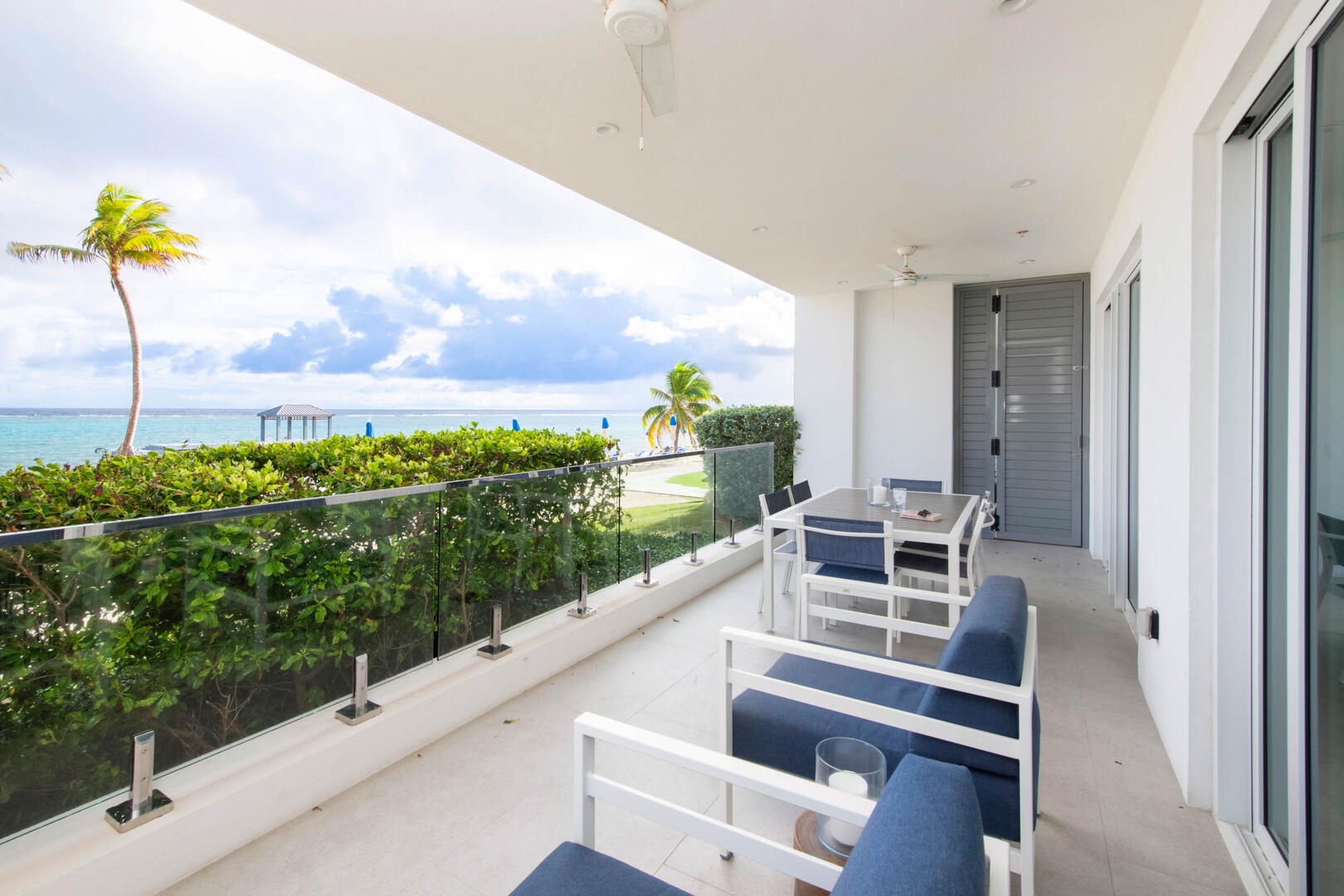 Furnished veranda for alfresco dining by the sea.