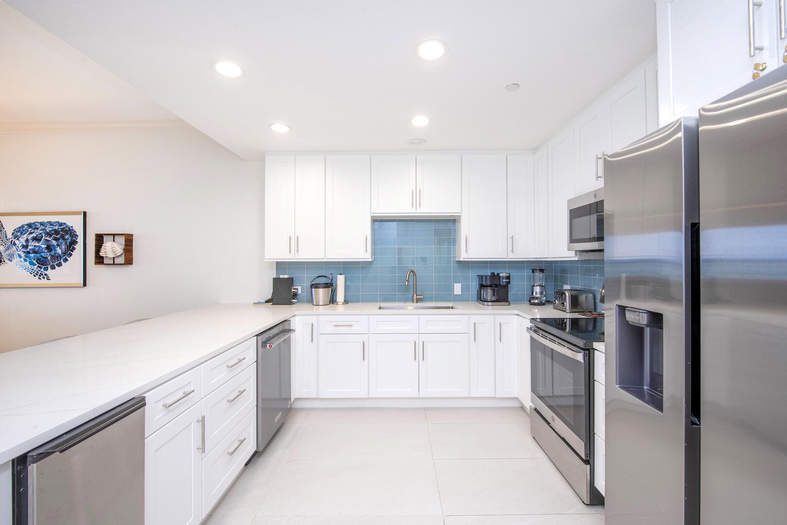 The kitchen is equipped with standard appliances plus an undercounter ice maker, drip coffee machine, and a blender.