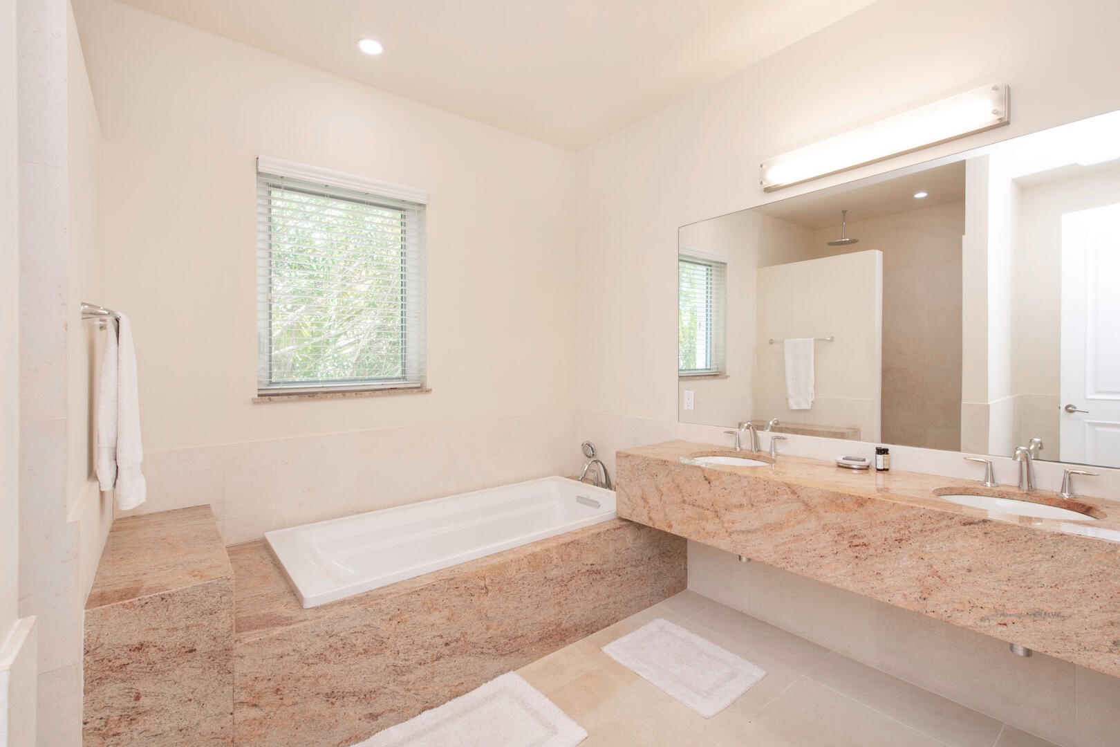 Guest Ensuite #3 with dual vanity, soaking tub, and separate shower.