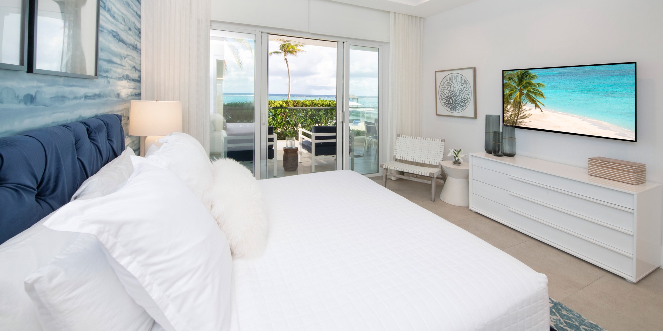 Second primary suite with king bed and walkout access to the ocean terrace.