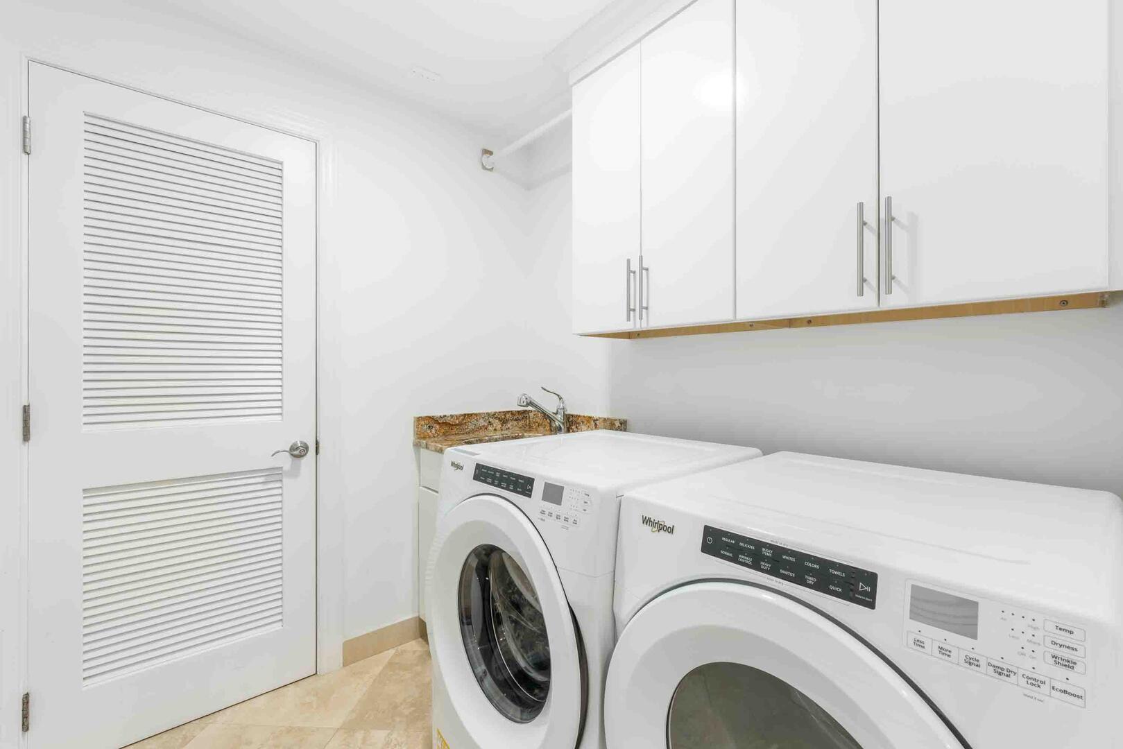 In-unit laundry with washer, dryer, and utility sink.