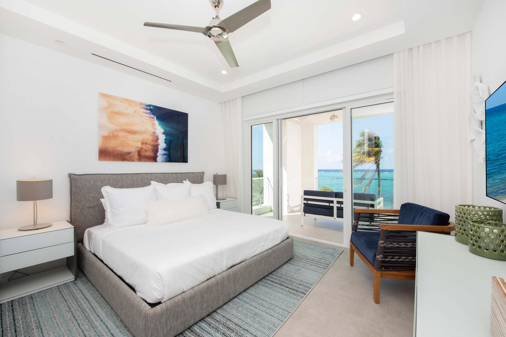 Primary Suite #2 with king bed, SmartTV, and walk-out access to the furnished balcony.