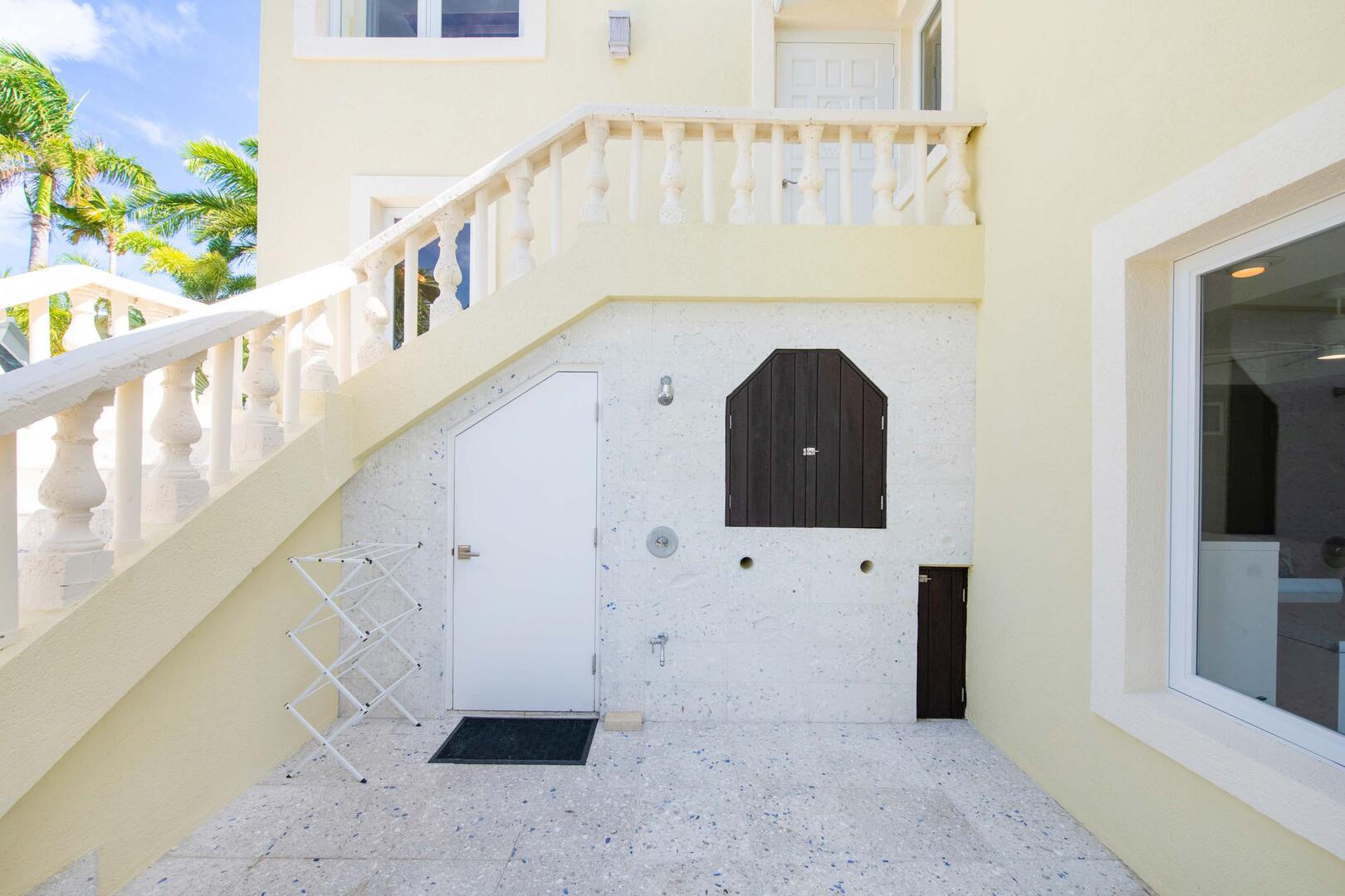 Outdoor shower to help keep sand outside the home.