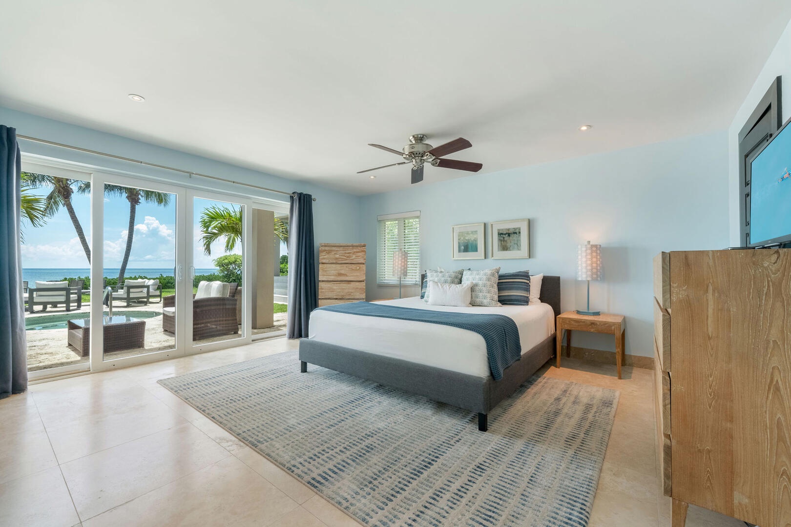 West Suite with California king bed and walk-out access to the pool deck.