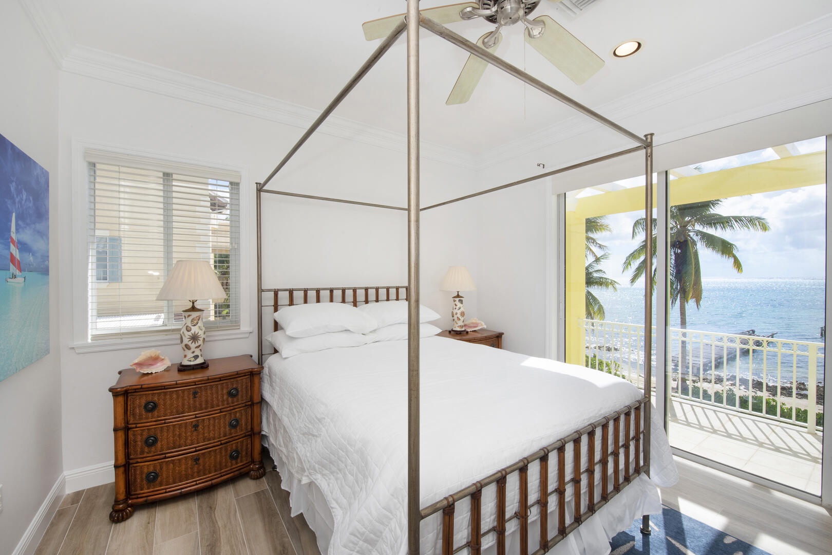 Bedroom 3 on the upper level with queen bed and walk-out access to the dining balcony.