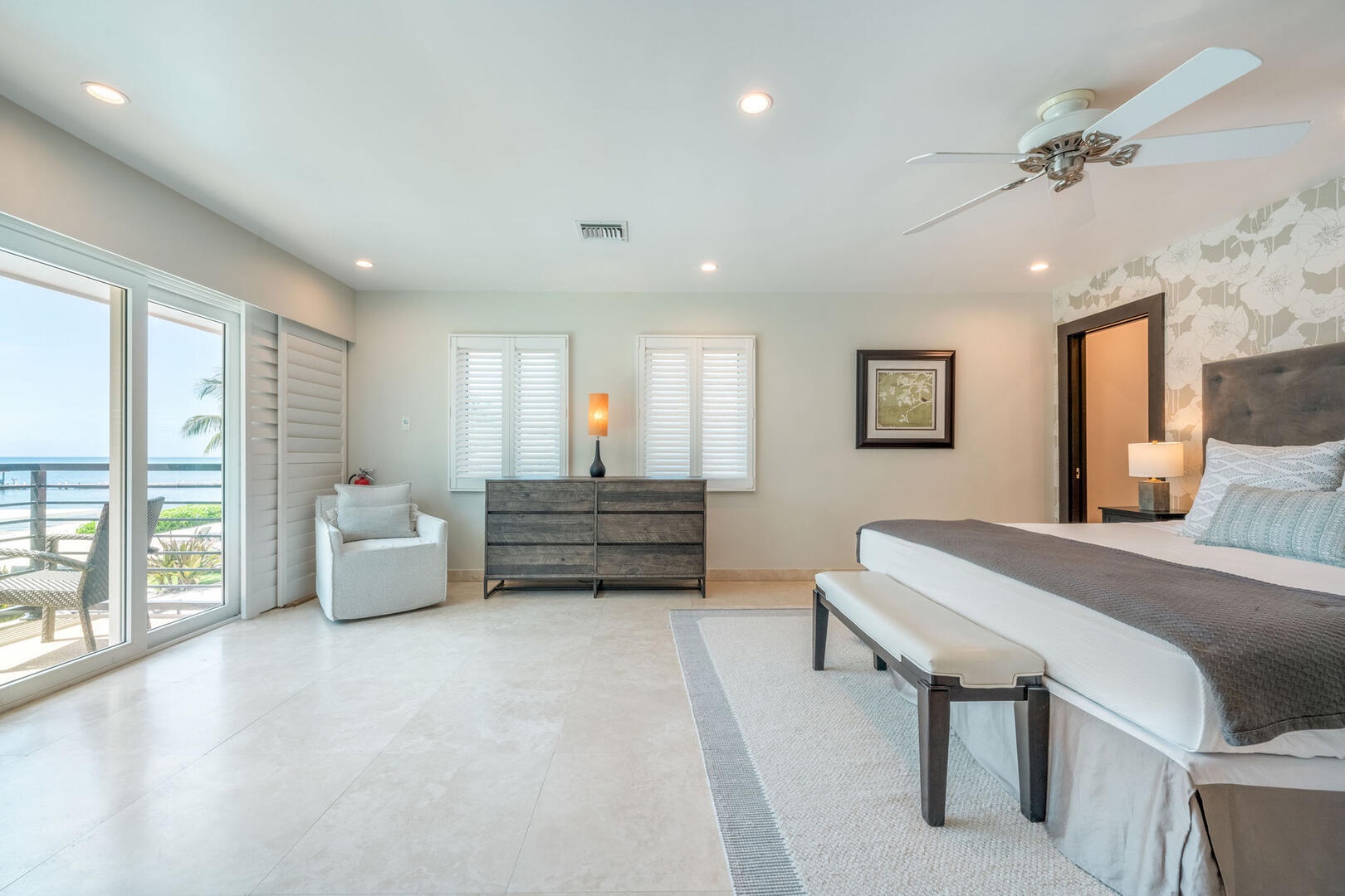 East Primary Suite with king bed and a private balcony.