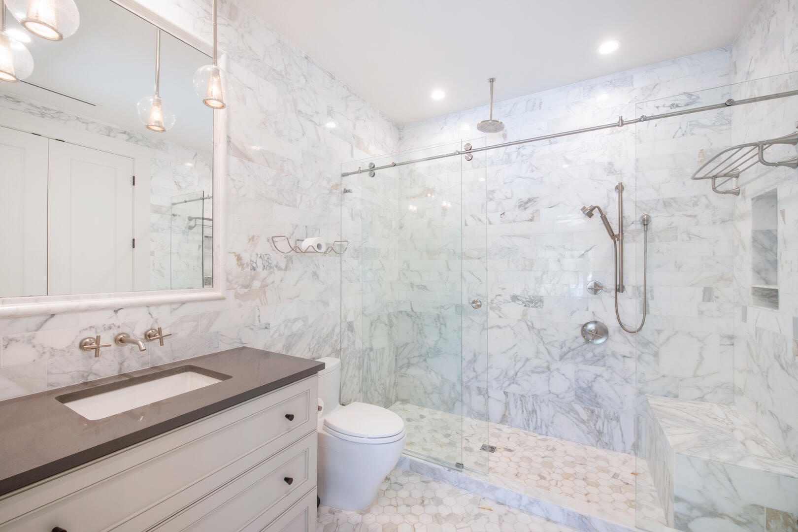 Primary Ensuite with rainfall shower, water wand, and shower bench.