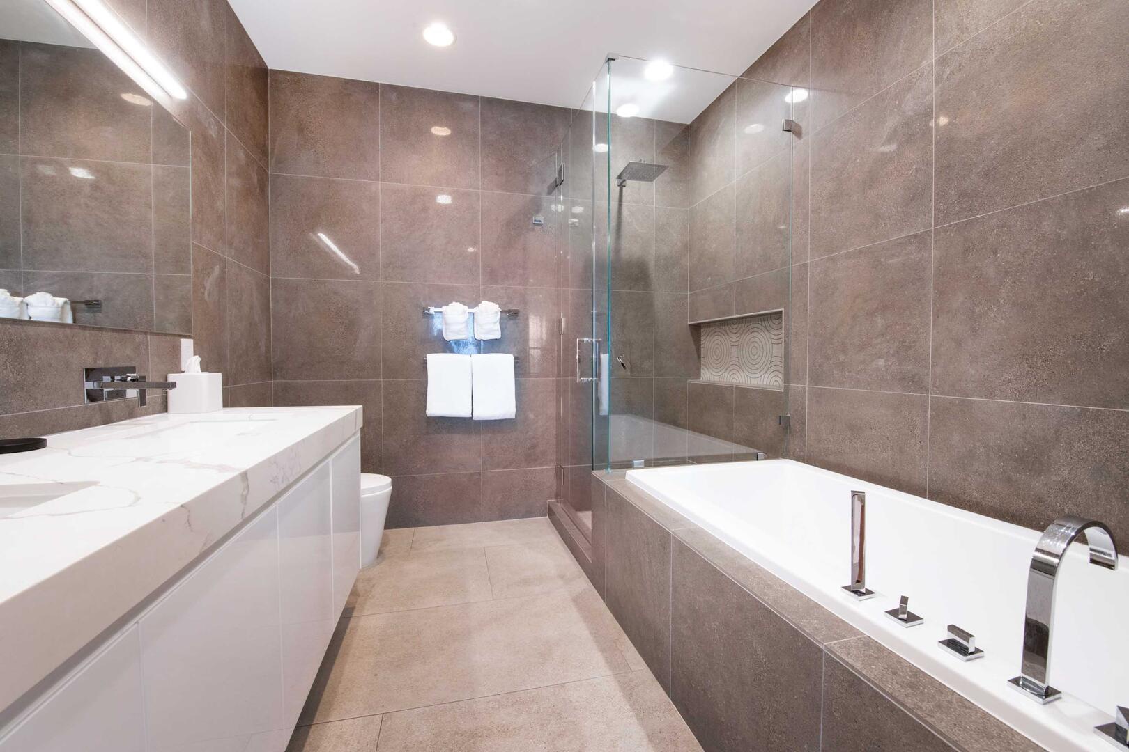 Primary Ensuite with dual vanity, soaking tub, and walk-in shower.