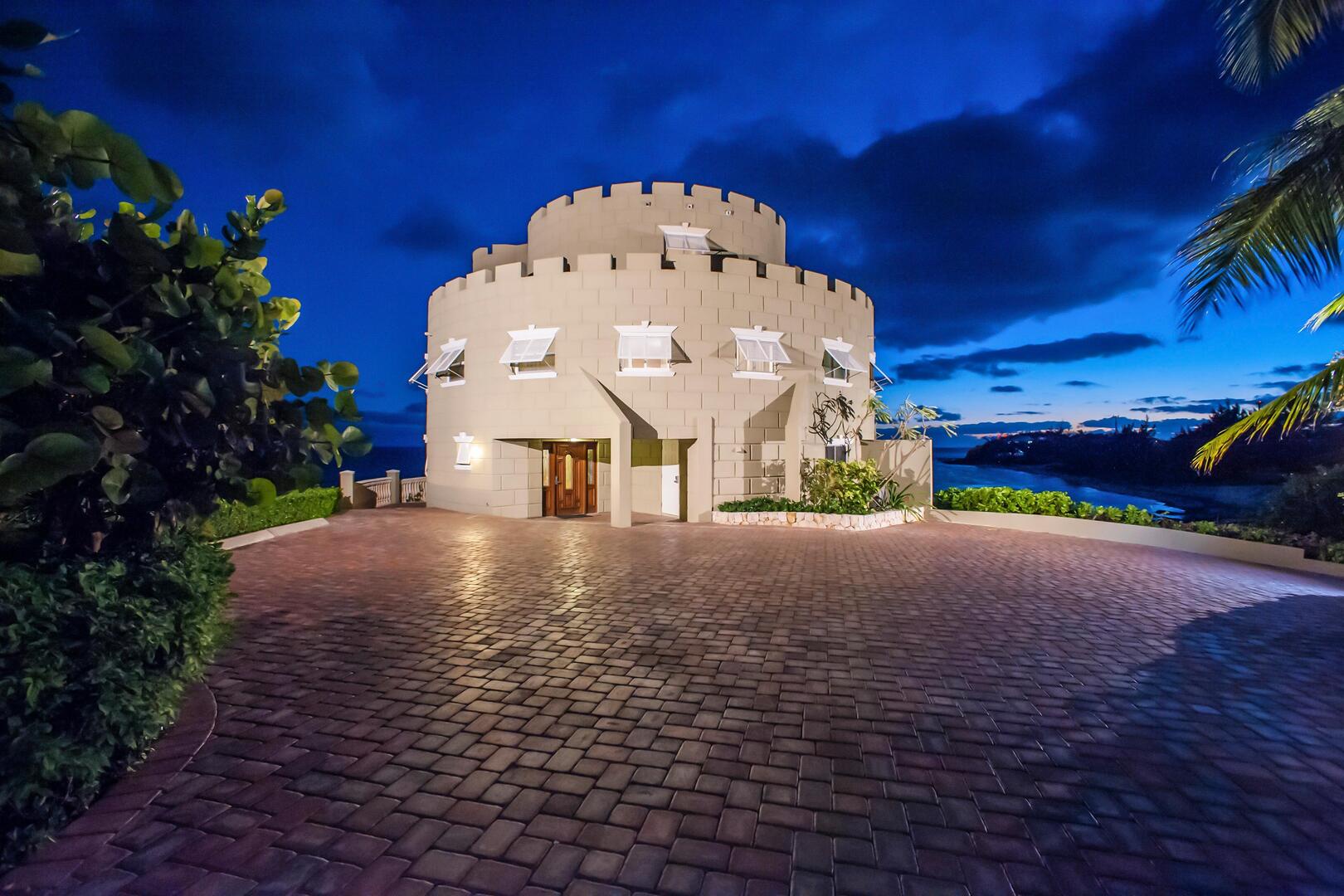 View of Cayman Castle from the driveway at dusk.
