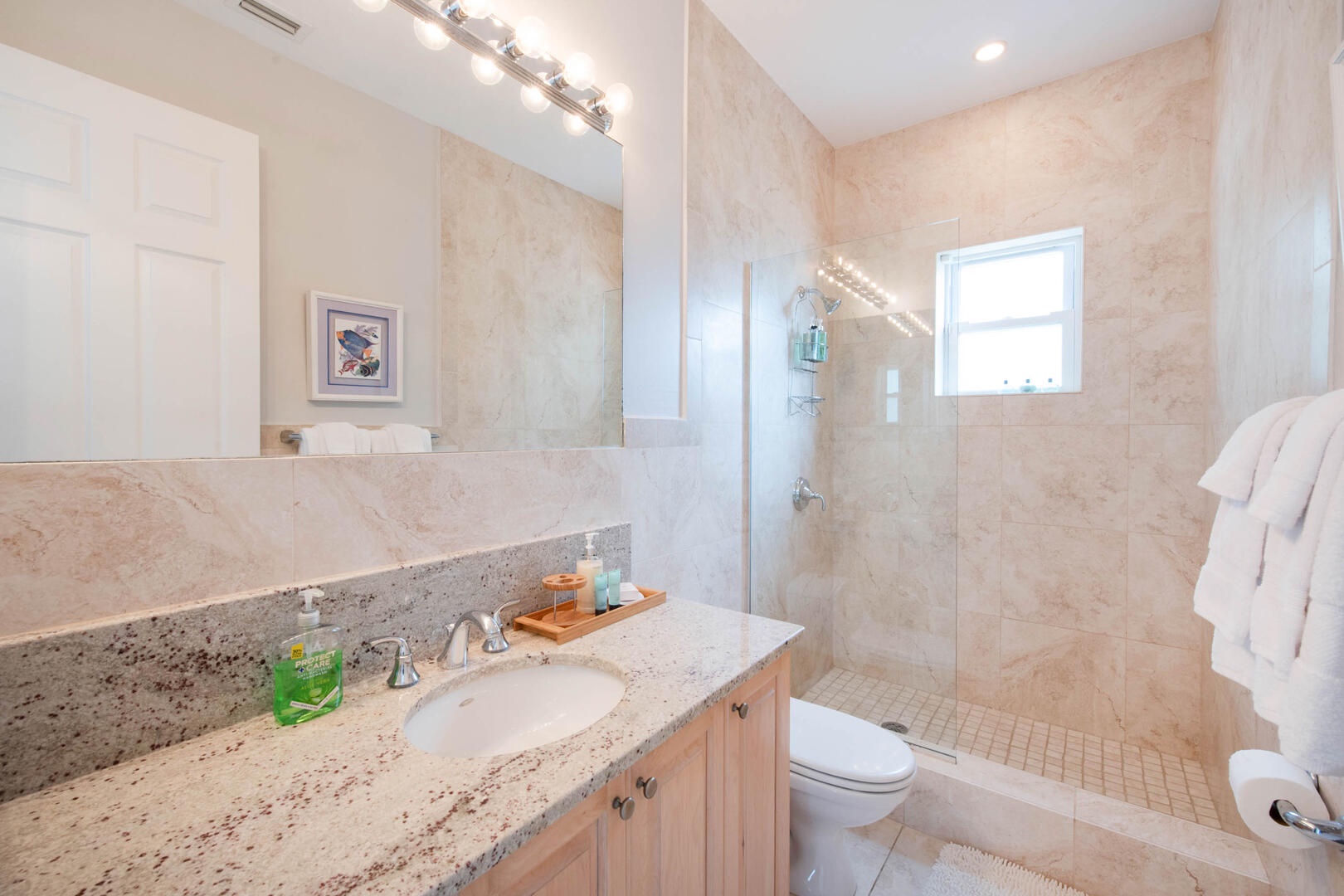 Guest Suite 1 ensuite bathroom with walk-in shower and tub.