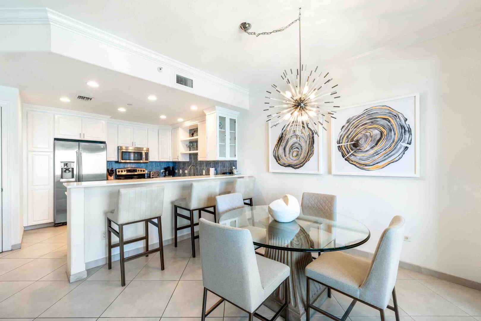 Renovated dining area and full kitchen with breakfast bar.
