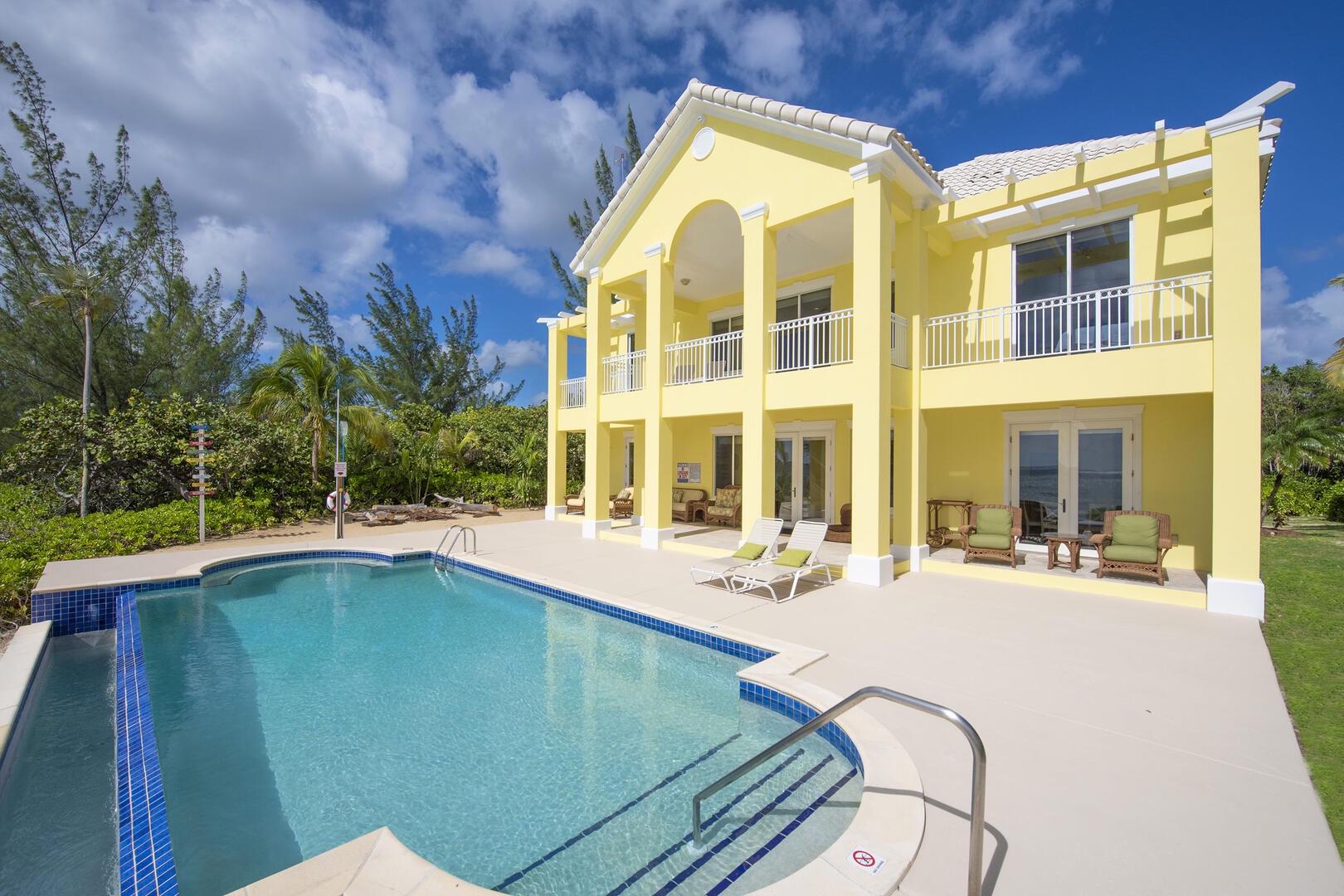 This oceanfront oasis spans 6-bedrooms with one on the lower level, 4 on the upper level, and 1 in the detached guest house.