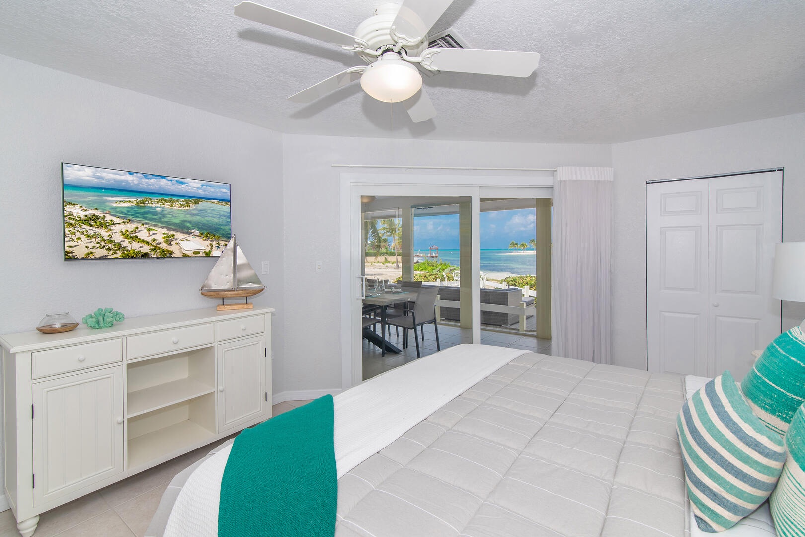 Guest Bedroom #1 with SmartTV, ocean views, and walk out access to the screened porch.