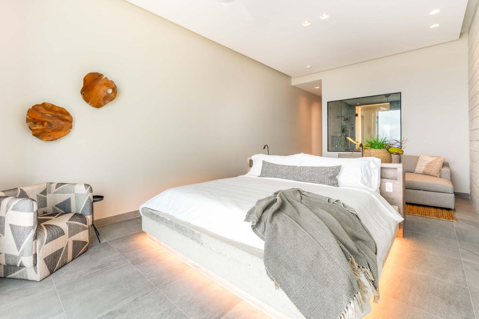 Oceanfront king suite 1 - king platform bed, desk, oceanfront floor-to-ceiling glass doors, 65" TV w/swivel mount, beverage fridge, coffee center, upholstered chair, sofa