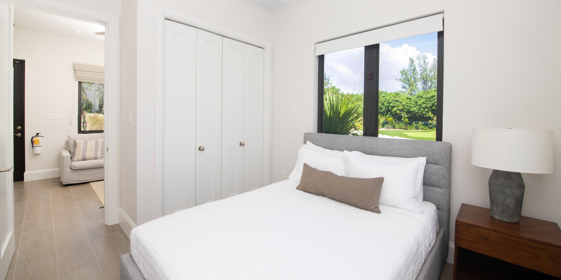 Bedroom 6 in the guesthouse furnished with a queen bed.