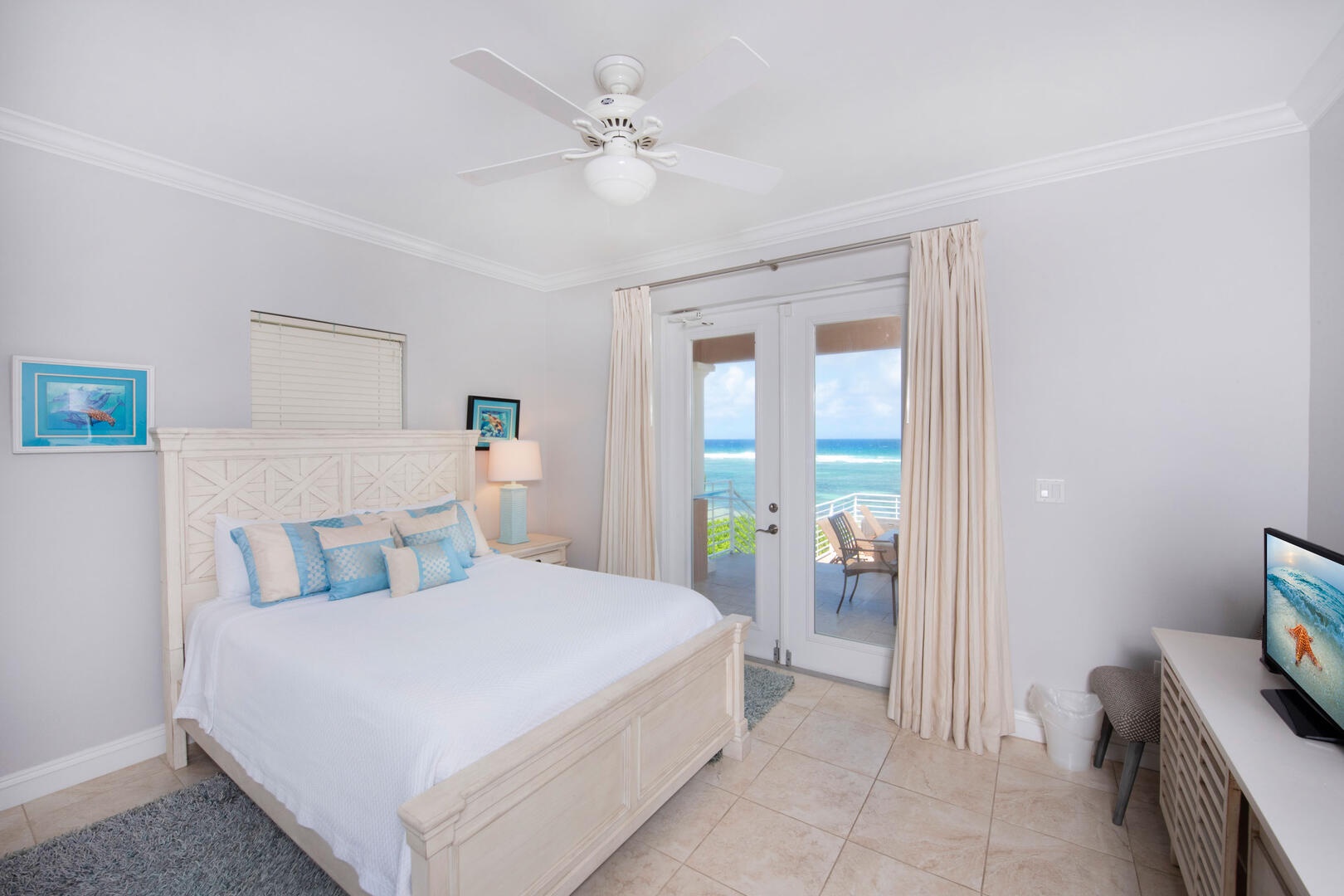 Guest Suite 1a with Queen bed, doors to the pool deck, spectacular ocean views