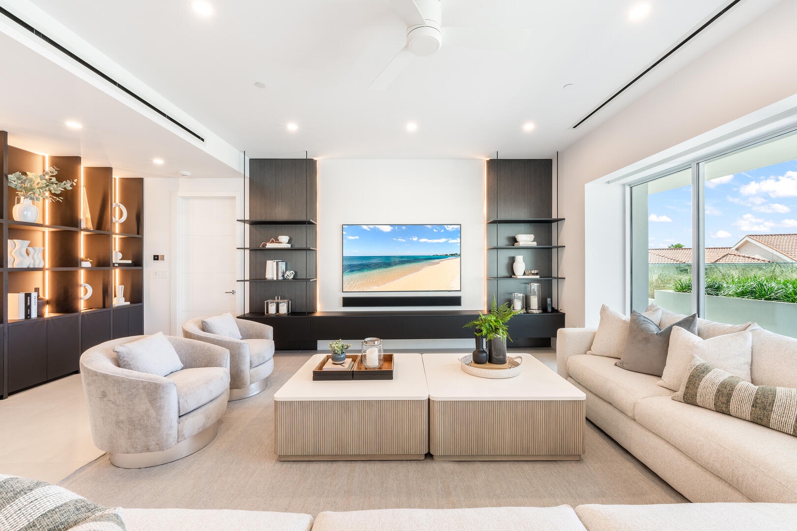 The living area is furnished with plush sectional sofas, and an HD cable television.