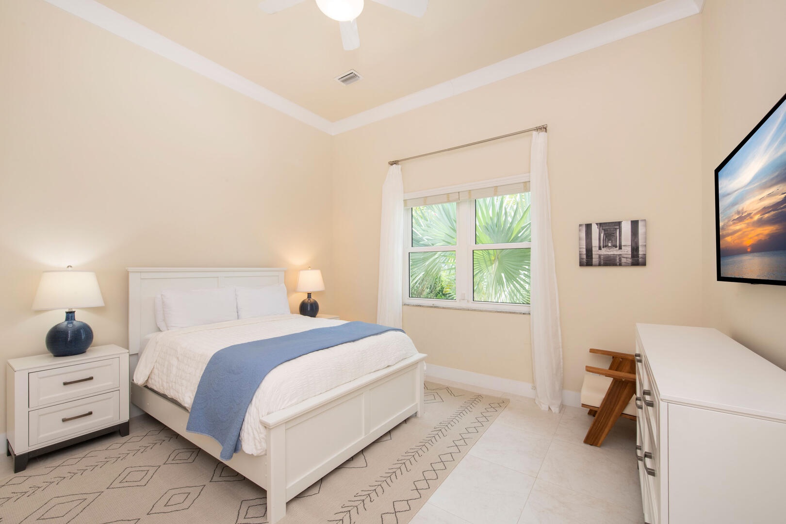 Guest Suite #4 with queen bed and television.