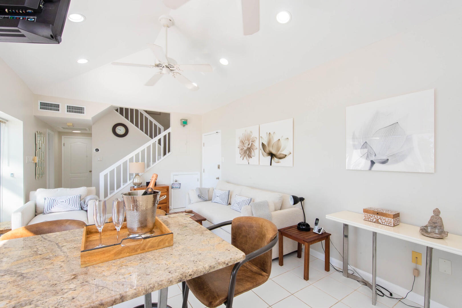 Living area with stairs leading to the primary suite.