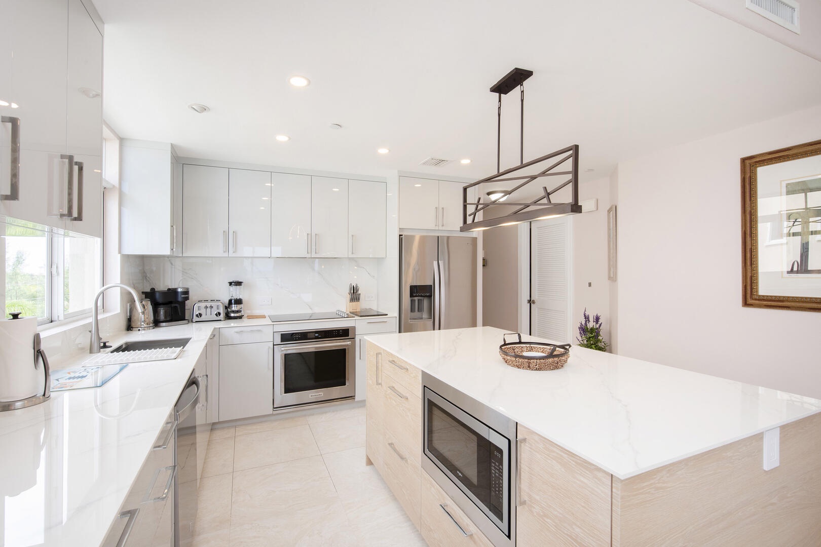 New kitchen island and countertops with small kitchen gadgets.