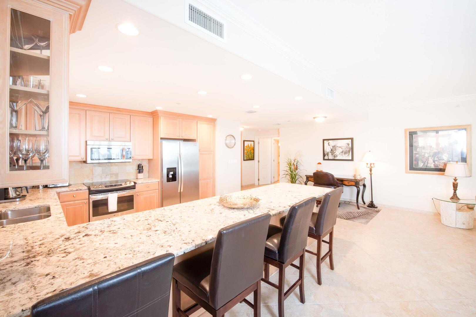 Full kitchen with breakfast bar seating. There's also a desk & chair for remote working professionals.