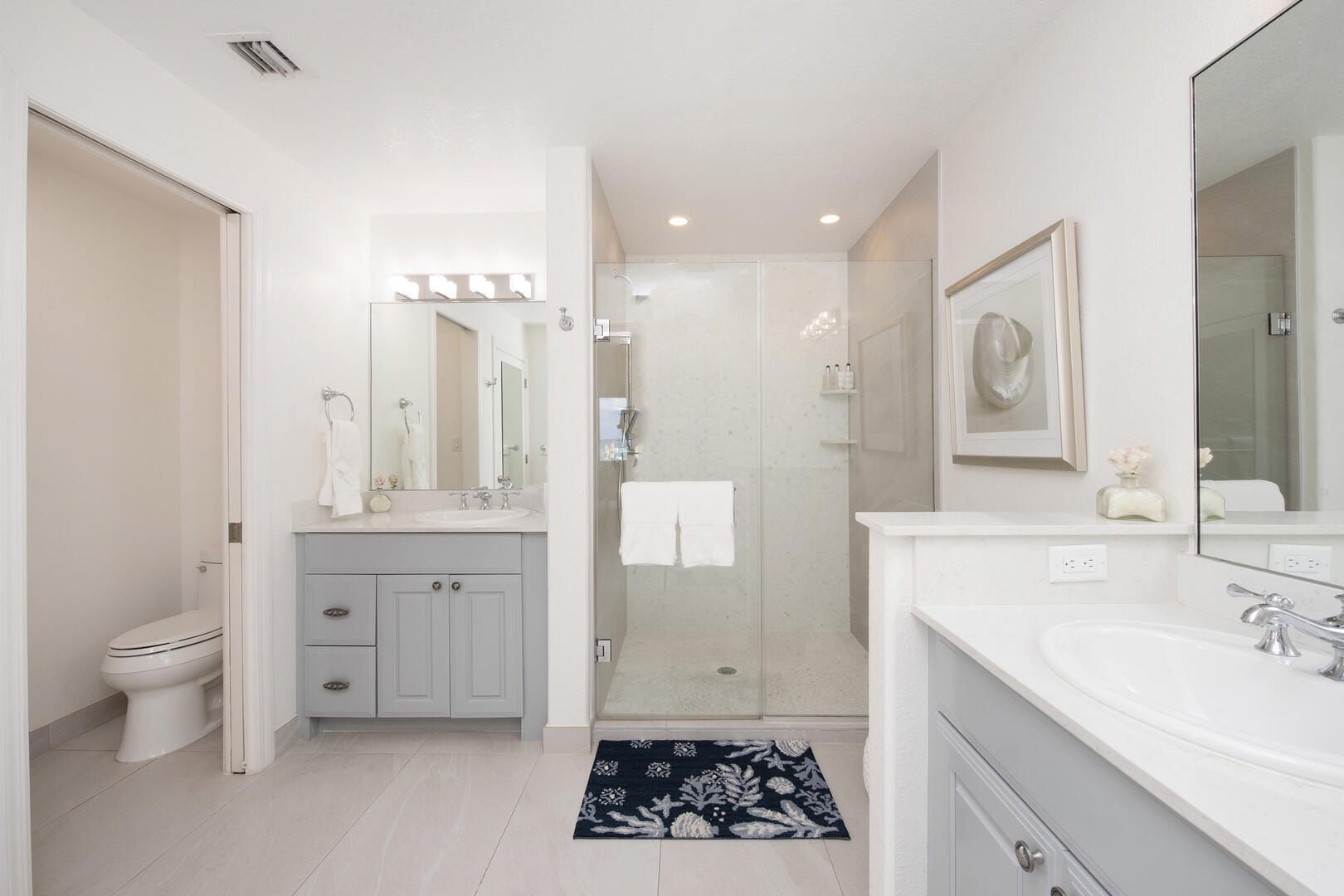 Primary ensuite with dual vanities and shower.