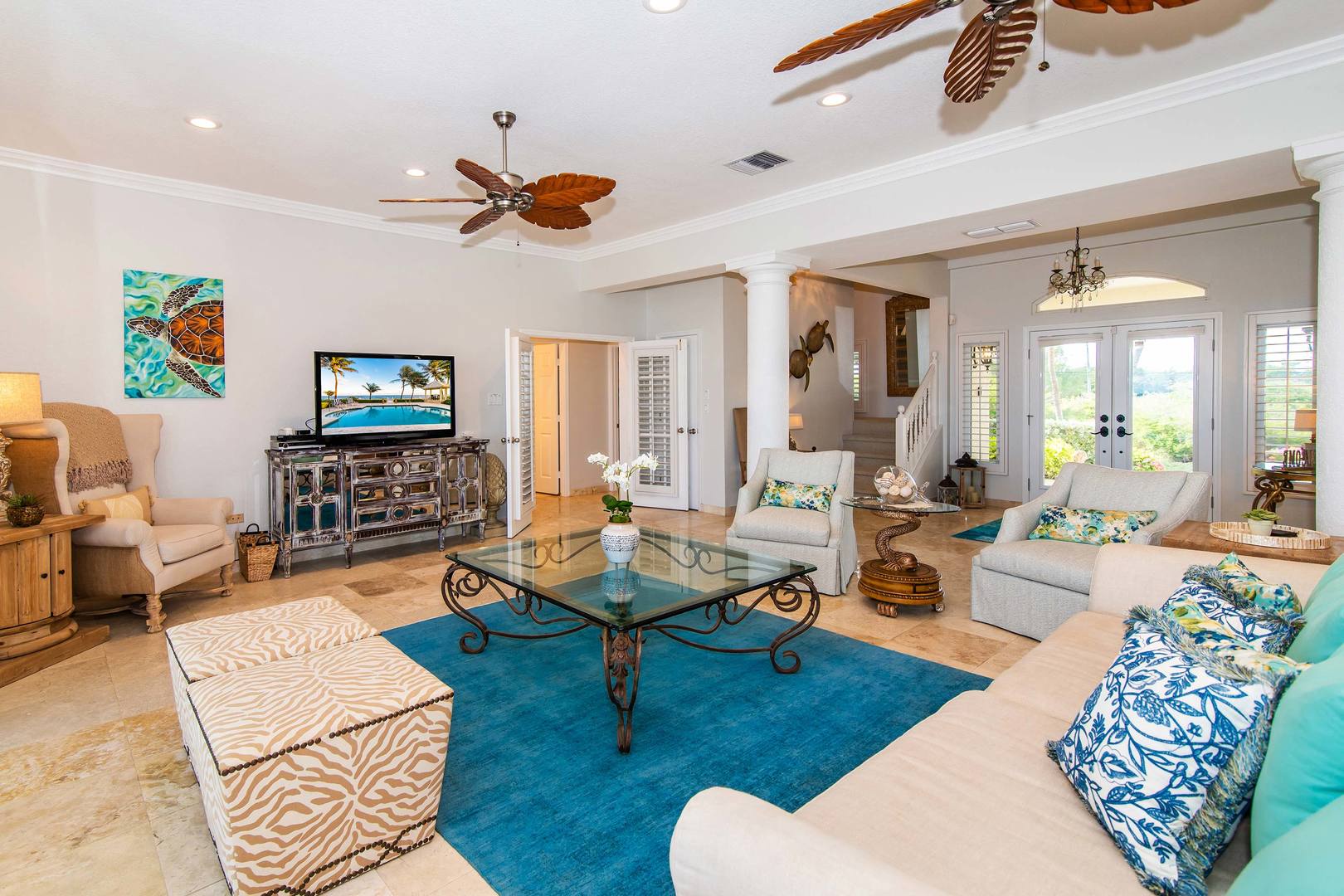 Spacious living area with sofa seating and television.