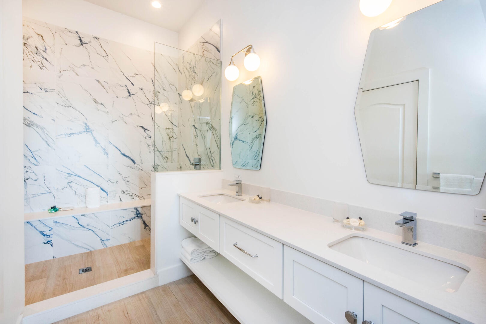 Primary ensuite with dual vanity and shower.