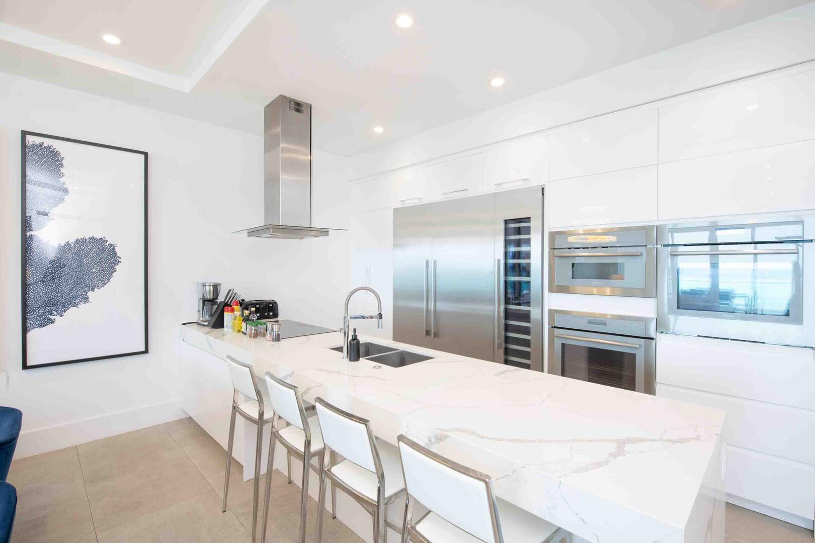 Gourmet kitchen with top-of-the-line appliances and island seating for 4.
