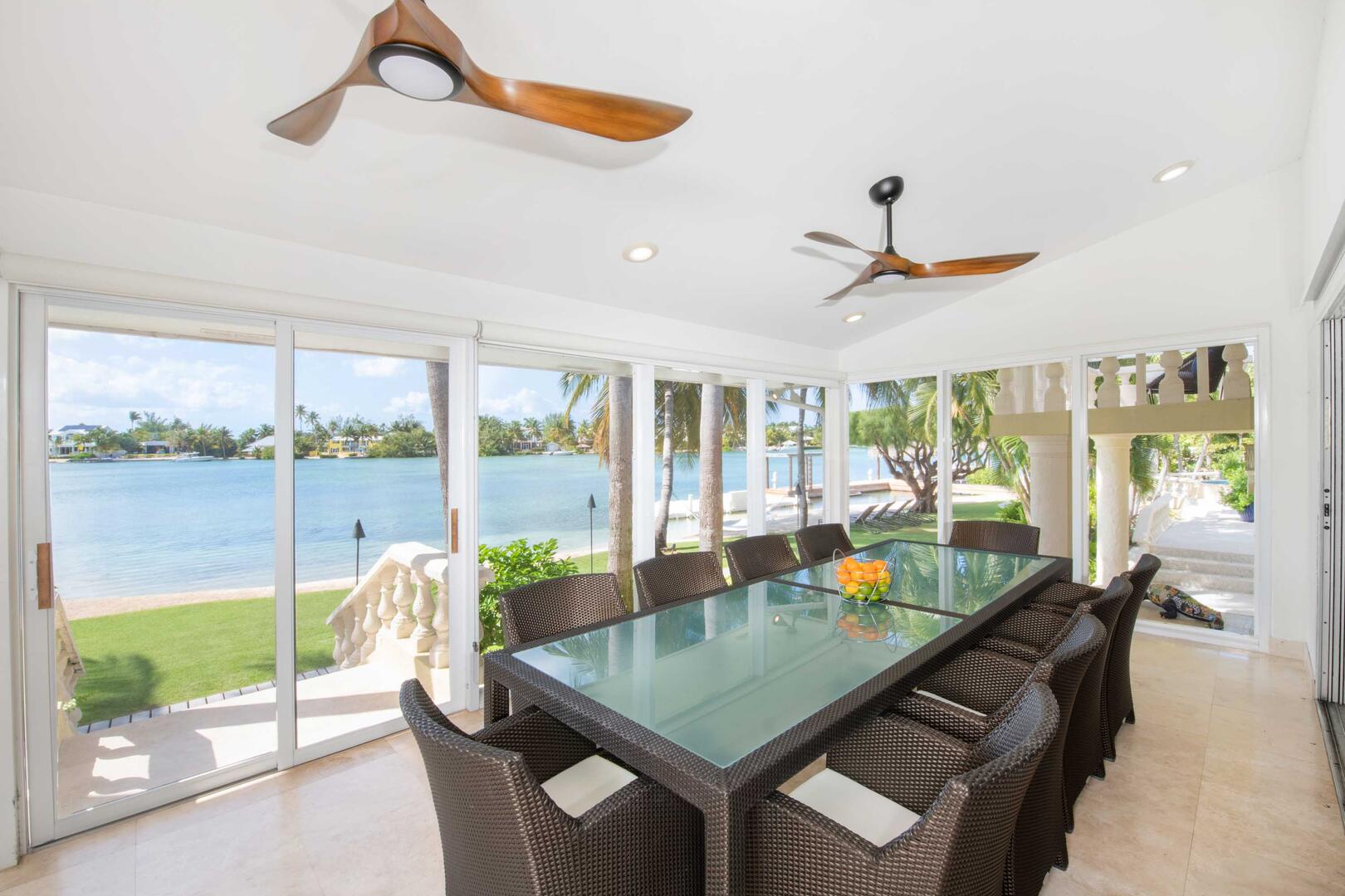 Sun room dining table with walkout access to the beachfront.