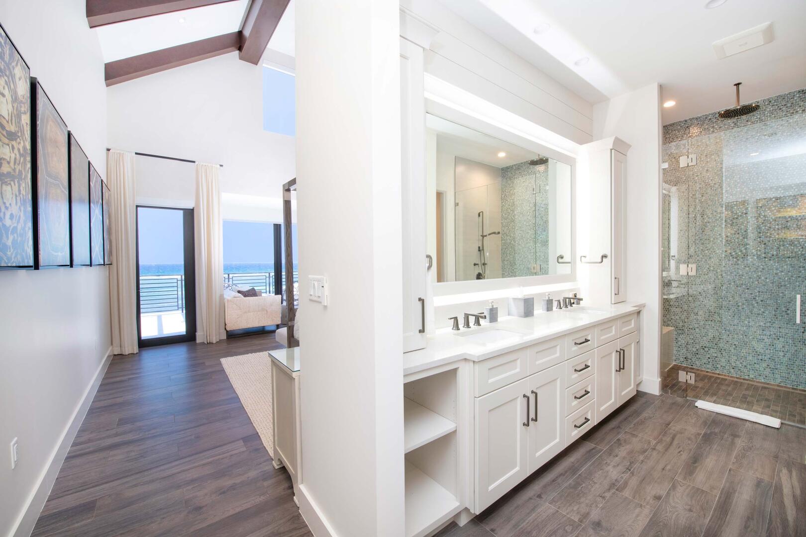 Primary Suite ensuite bath with double vanity, makeup station, and tiled shower.