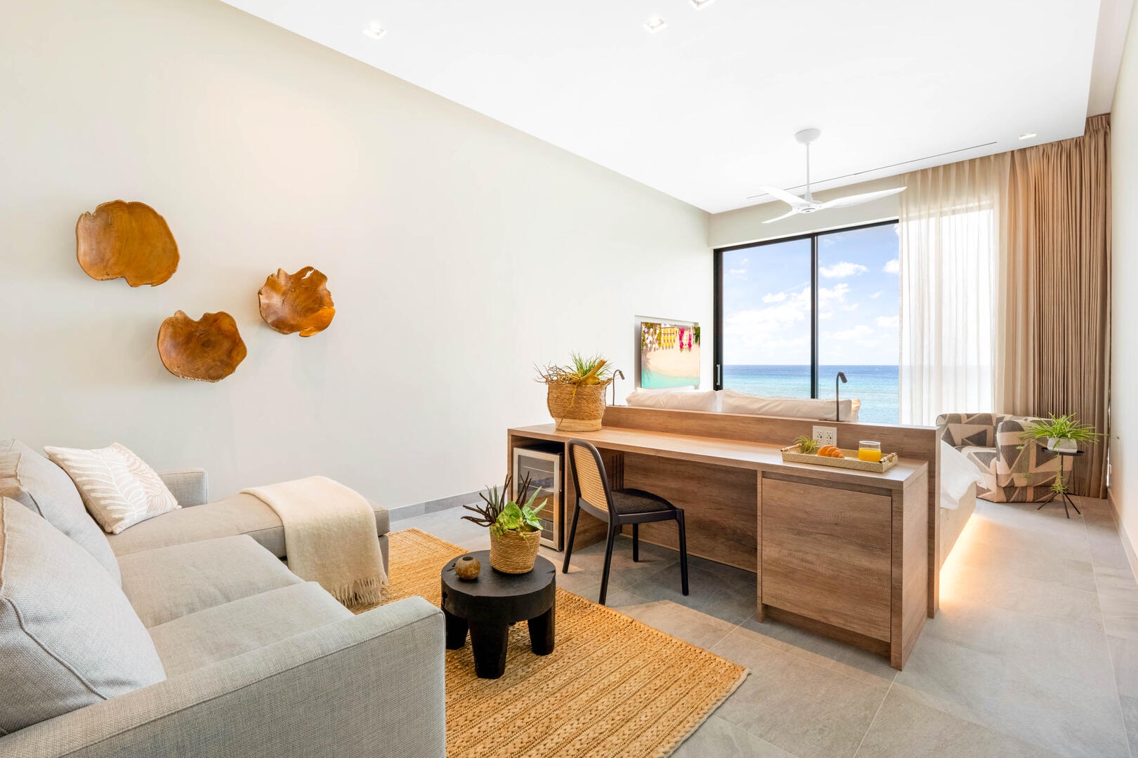 Oceanfront king suite 3 - king platform bed, desk, oceanfront floor-to-ceiling glass doors, 65" TV w/swivel mount, beverage fridge, coffee center, upholstered chair, sofa